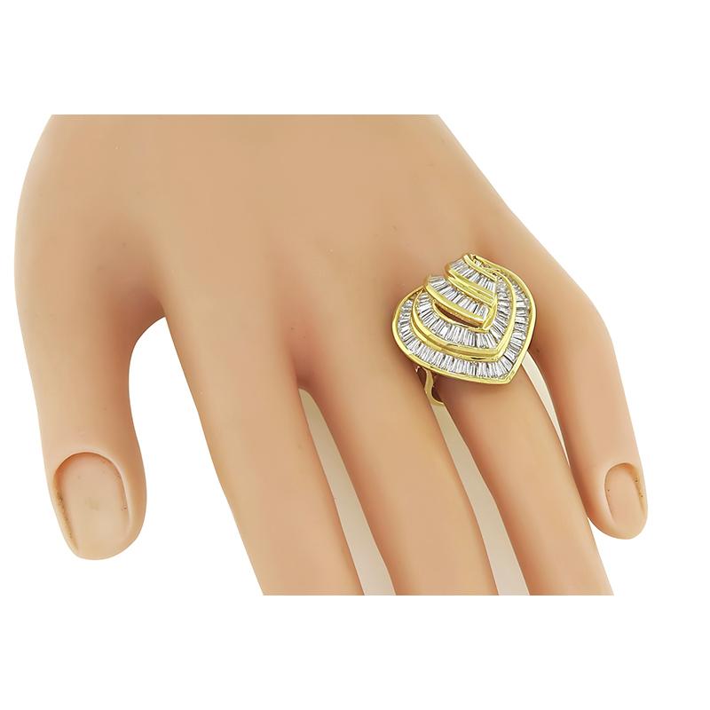 This is an amazing 18k yellow gold ring. The ring is set with sparkling baguette cut diamonds that weigh approximately 3.72ct. The color of the diamonds is G with VS clarity. The top of the ring measures 23mm by 23mm. The ring is stamped K18 D3.72