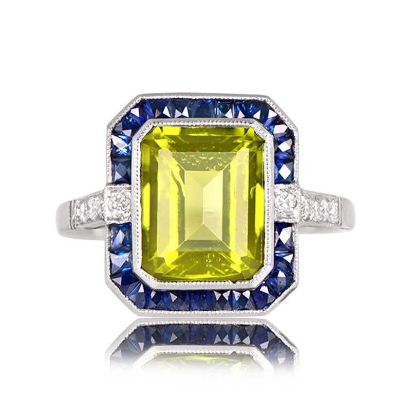 A captivating Peridot ring showcasing a 3.72-carat emerald cut peridot with vivid saturation. The center gem is encircled by a row of sapphires and two diamonds. This platinum ring is accentuated by diamonds on the shoulders.

Ring Size: 6.5 US,