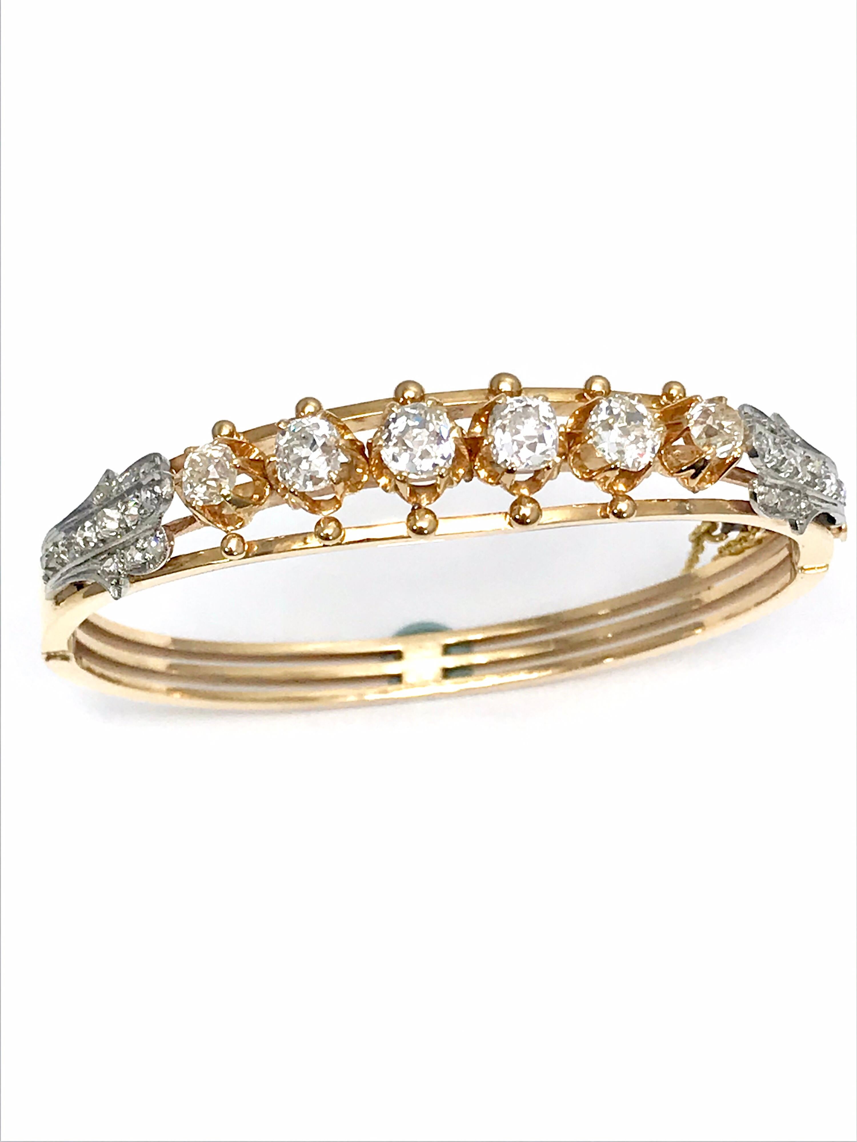 An absolutely gorgeous Victorian old mine cut and rose cut Diamond 18 karat rose gold bangle bracelet. There are six old mine cut Diamonds prong set in the center of the bracelet, totaling 3.00 carats, with rose cut Diamonds set in platinum to each
