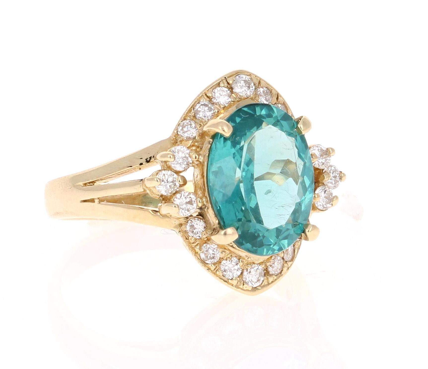 Classic and beautifully designed Apatite and Diamond Ring!  This ring has a 3.33 carat Oval Cut Apatite in the center of the ring and is surrounded by 18 Round Cut Diamonds 0.40 carats. The total carat weight of the ring is 3.73 carats.  

The ring