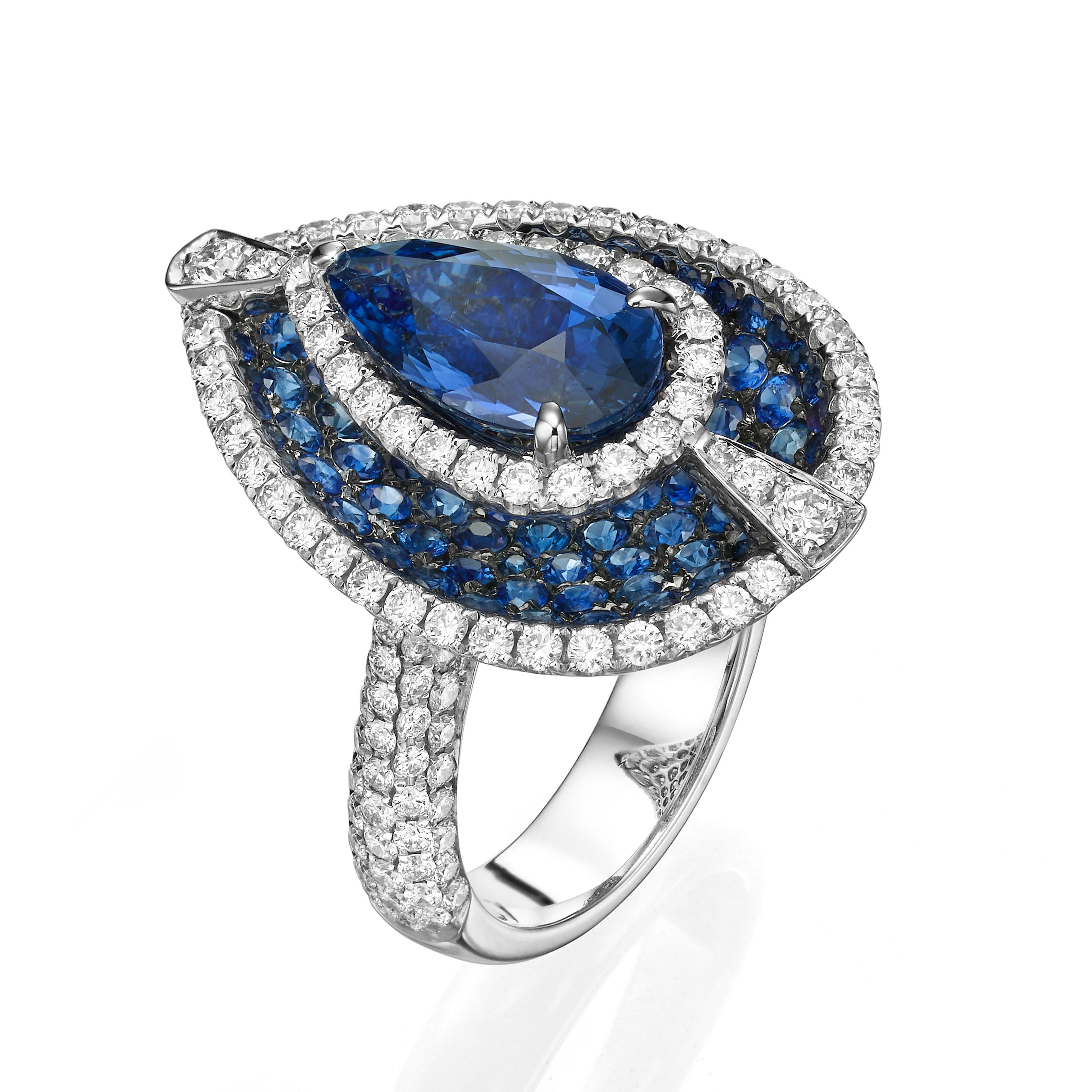 Crafted with a stunning array of gemstones, Butani's opulent ring is molded from lustrous 18-karat white gold.  This design is set with a sizeable 3.73 carat teardrop-shaped blue sapphire surrounded by 1.52 carats of diamonds and 2.47 carats of blue