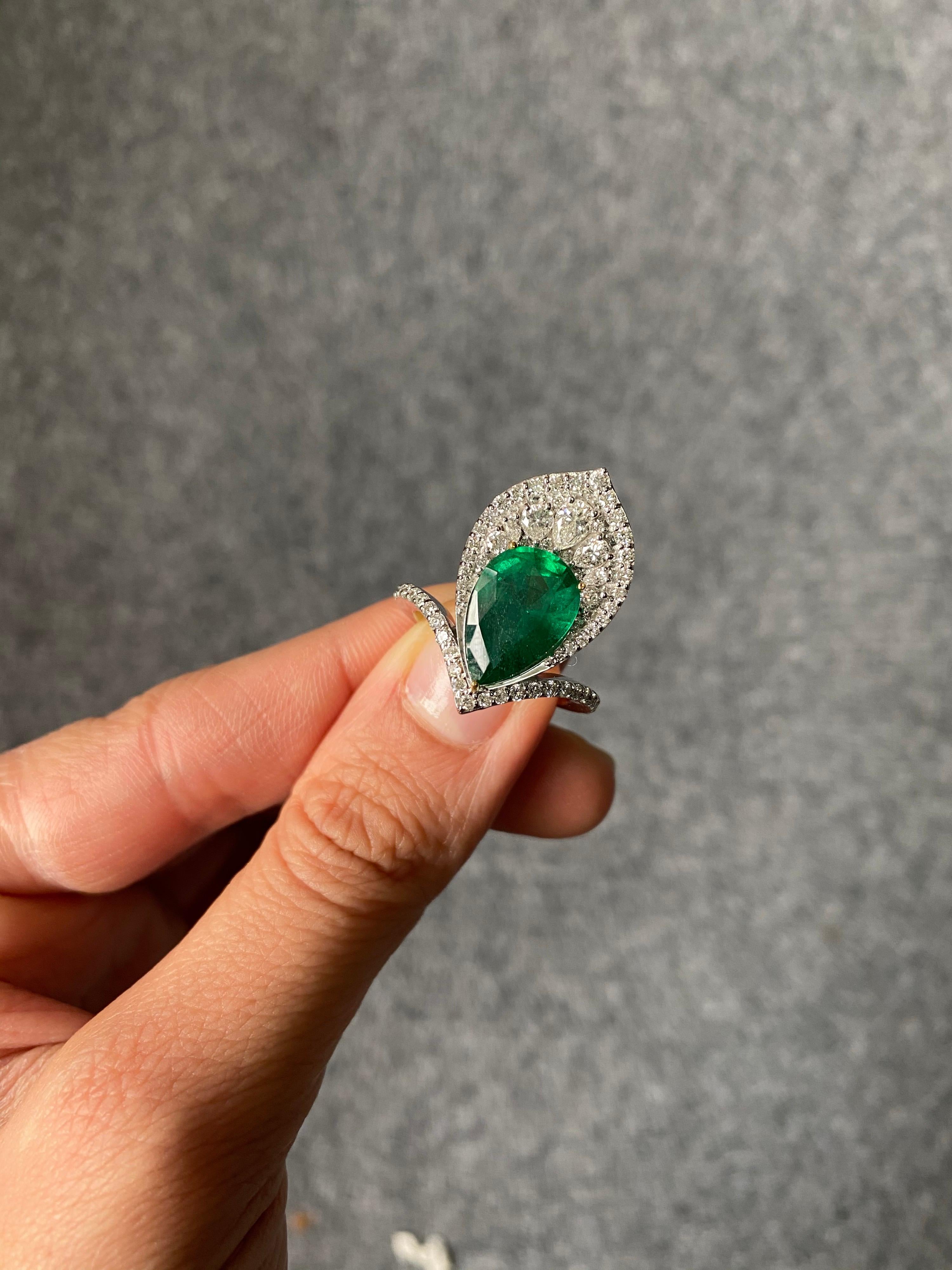Une bague de cocktail magnifiquement conçue, avec une émeraude de Zambie en forme de poire de 3,73 carats entourée de diamants incolores de qualité VS (en forme de poire et taille brillant) - le tout serti dans de l'or blanc 18 carats massif.