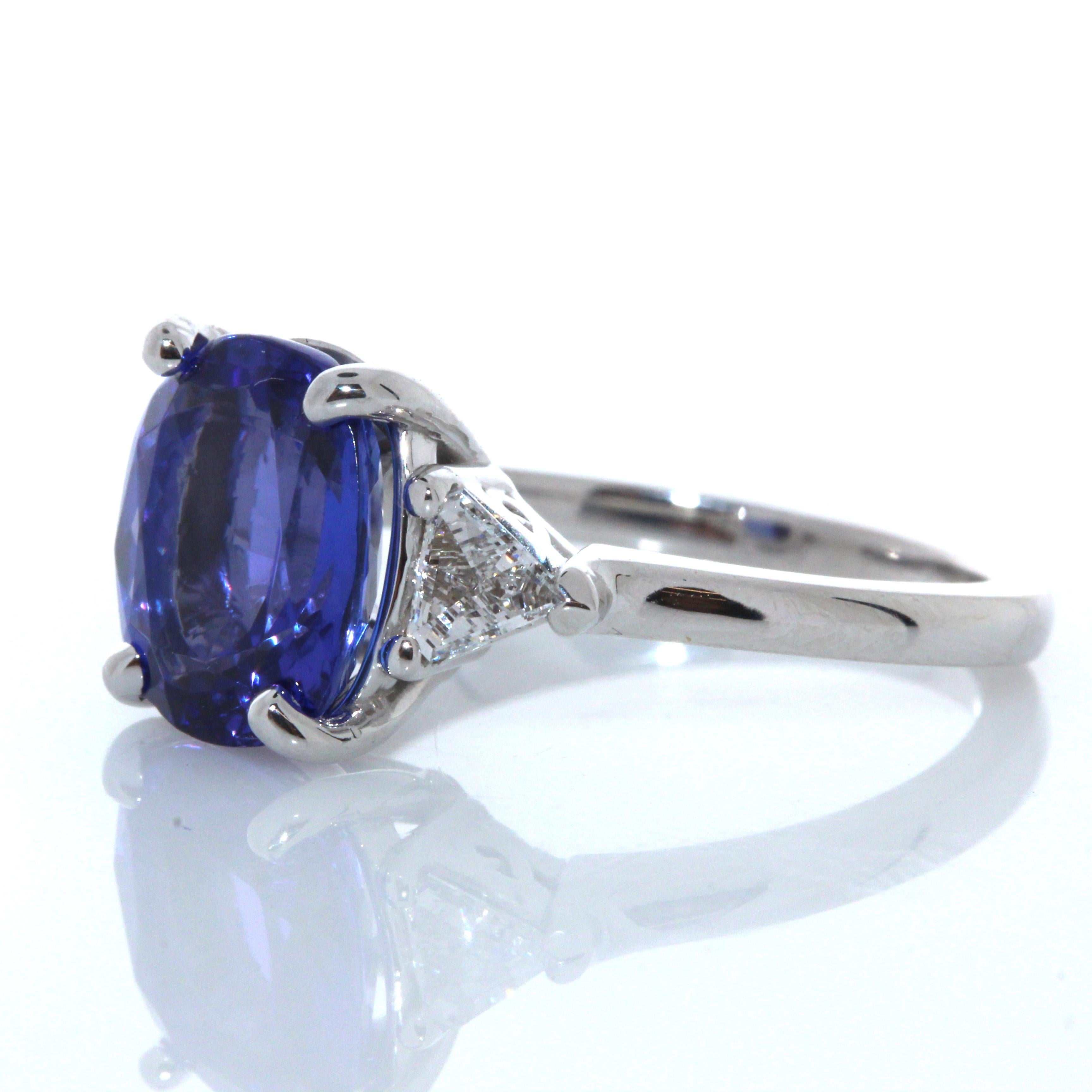 No one can resist being drawn in by the gorgeous 3.73 carat Cushion tanzanite center. The color of this gem is vivid blue-violet, sourced from the foothills of Mt. Kilimanjaro in Tanzania. Its color is the most desired - resembling fine blue