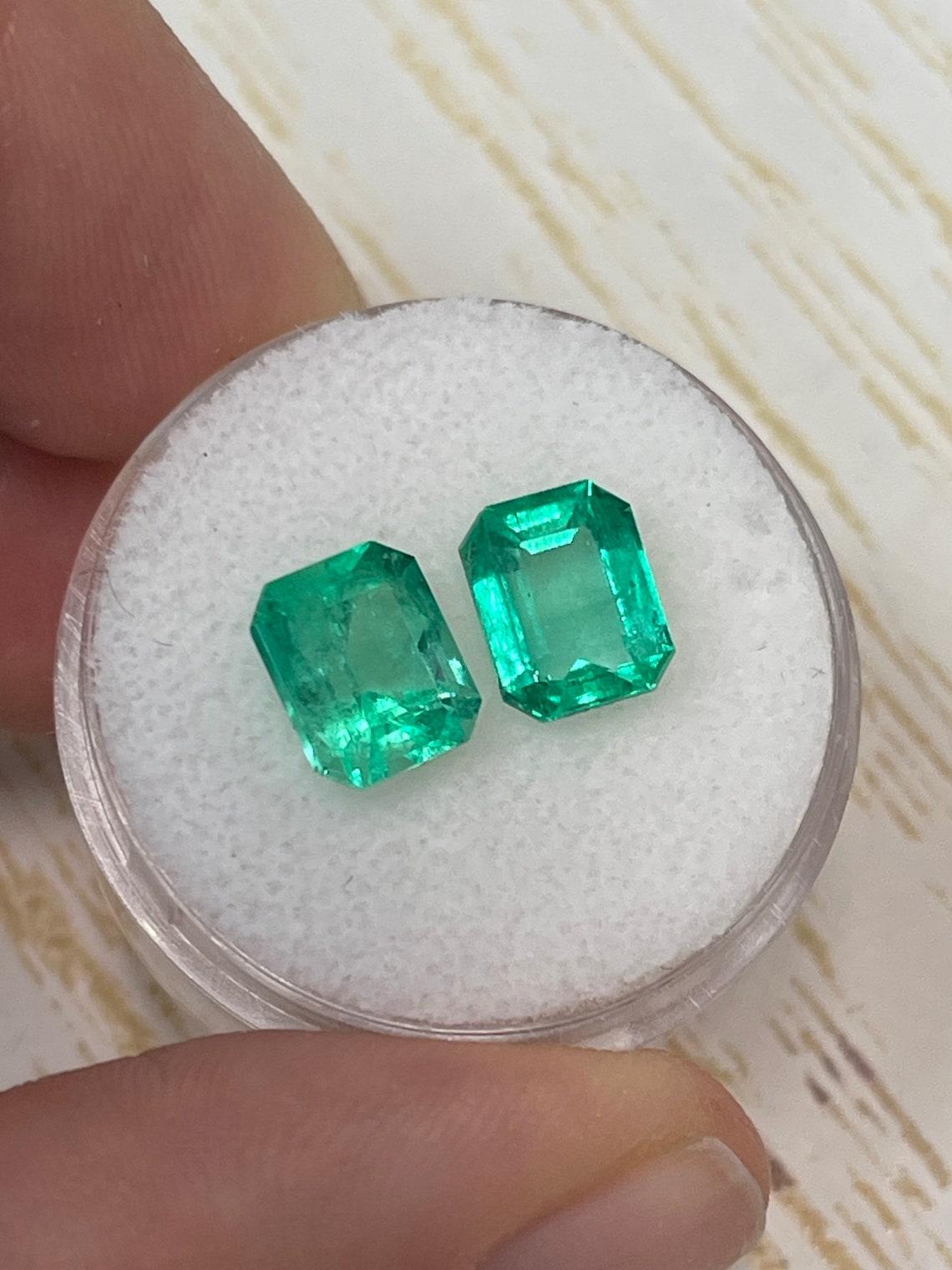 Stone: Emerald
Total Weight: 3.73-tcw
Shape: Emerald Cut
Clarity: Transparent
Luster: Very Good
Color: Yellowish Green
Measurements: 7.89mm x 6.67mm x 5.63mm // 8.10mm x 6.38mm x 4.56mm
Geographic Origin: Colombia
Treatment: Natural, Oil

No two
