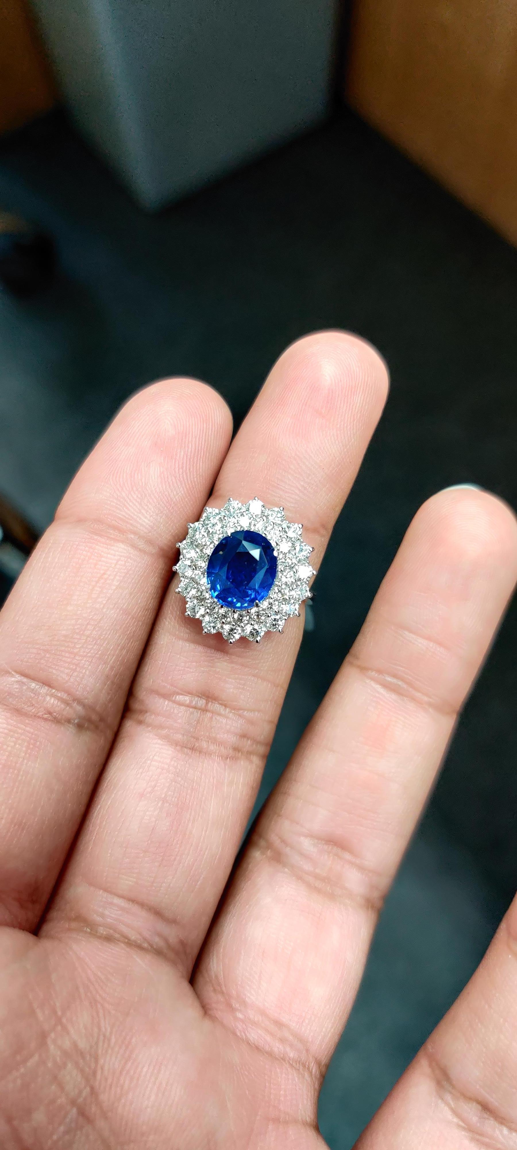 Introducing our exquisite 18K Gold Sapphire Ring, a true statement of luxury and elegance. This magnificent piece features a stunning 3.74 carat sapphire sourced from Sri Lanka, known for its exceptional quality and captivating color. Enhanced by