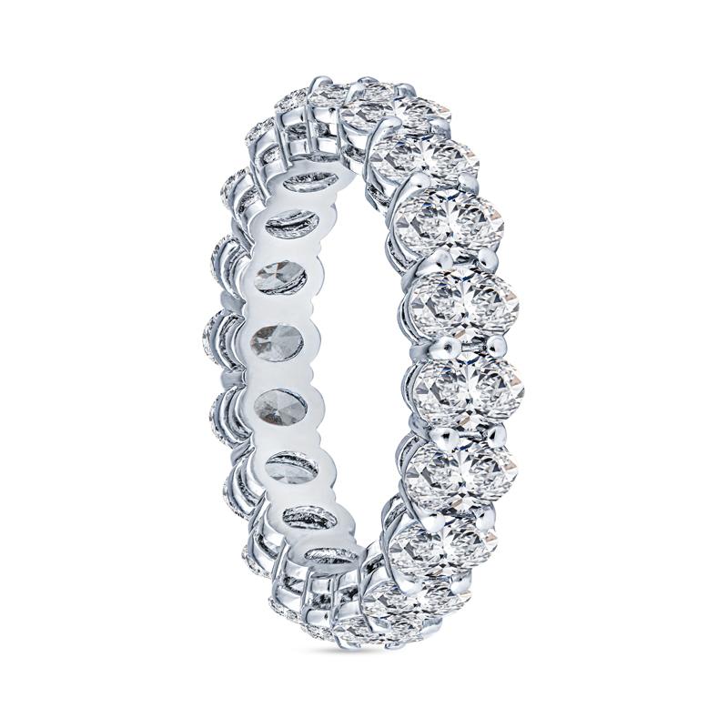 This beautiful eternity band features 3.74 carat total weight in near colorless oval diamonds, SI, set in platinum with an open basket low profile. This ring is a size 6. Please email us for alternate sizing.