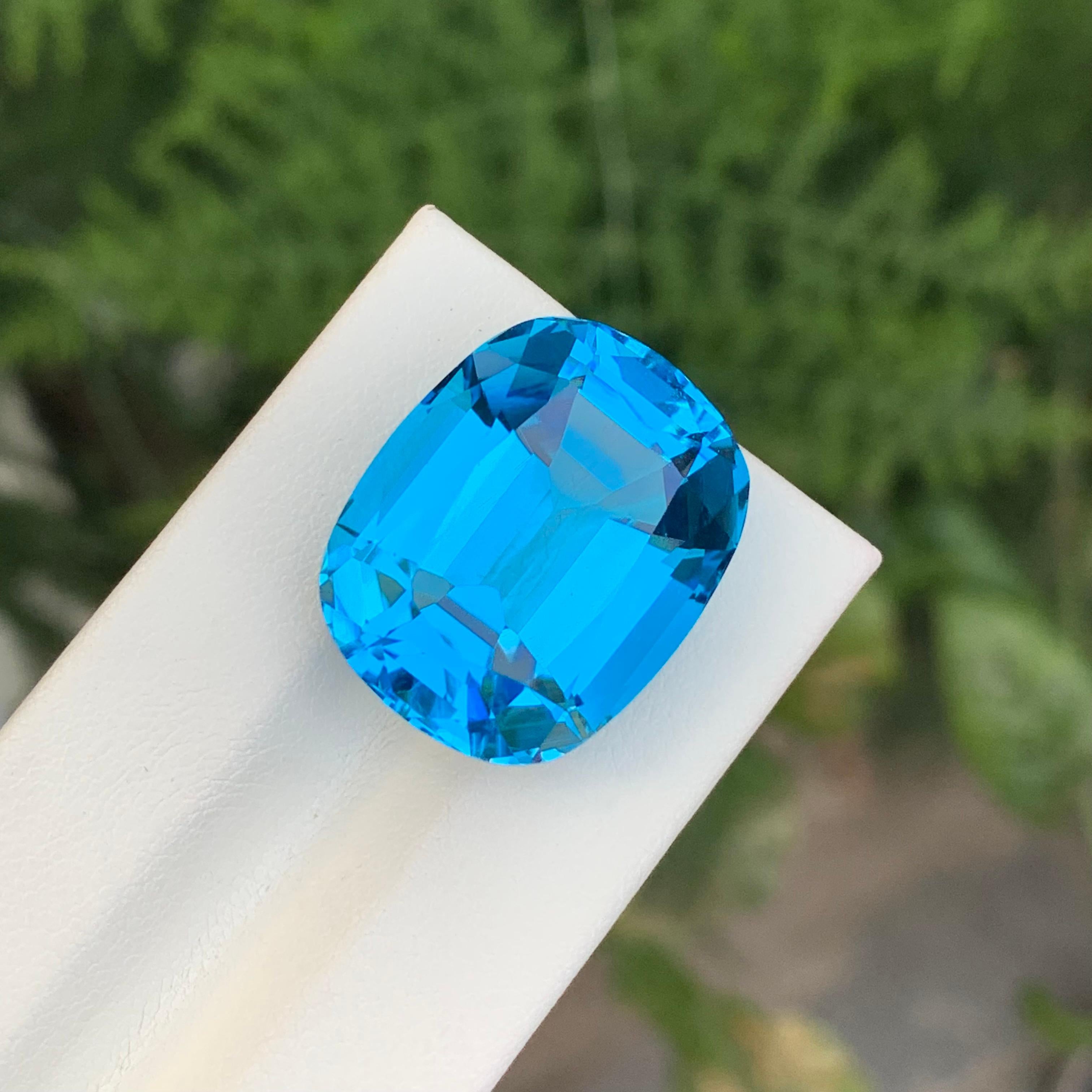 Loose Electric Blue Topaz
Weight: 37.45 Carats
Dimension: 21 x 16.9 x 12.2 Mm
Origin: Brazil
Shape: Cushion
Color: Electric Blue
Certificate: On Customer Demand

Benefits Of Wearing Blue Topaz Stone:
It helps to improve communication and