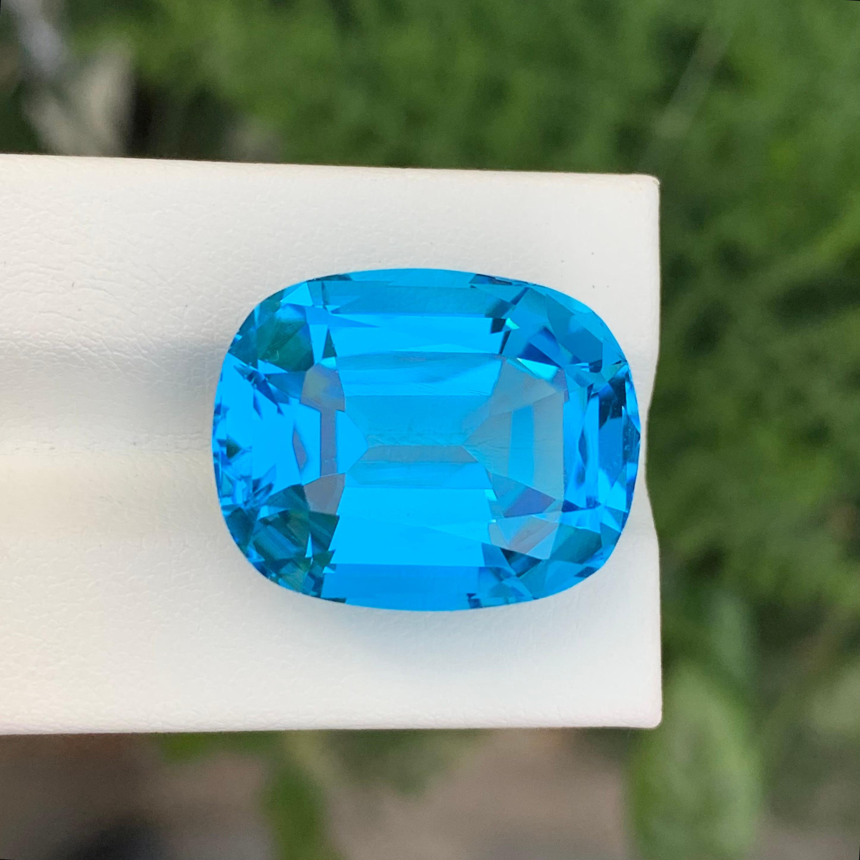 Women's or Men's 37.45 Carat Gorgeous Faceted Electric Blue Topaz Cushion Shape Gem For Sale