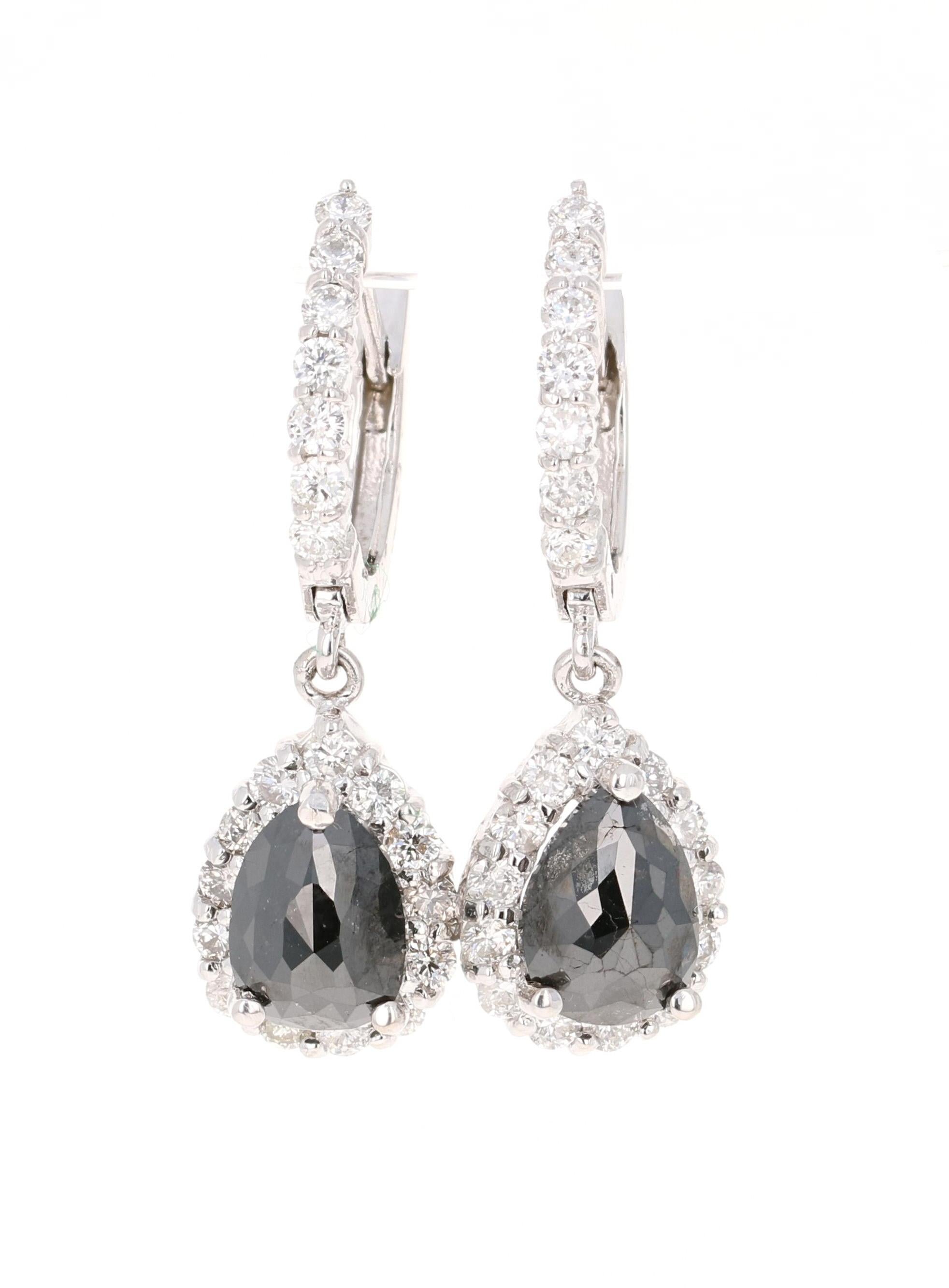 These beauties have 2 Black Pear Cut Diamonds that weigh 2.54 Carats and 40 Round Cut Diamonds that weigh 1.21 Carats. The total carat weight of the earrings are 3.75 Carats. The pear cut black diamonds measure at approximately 9 x 7 mm. The length