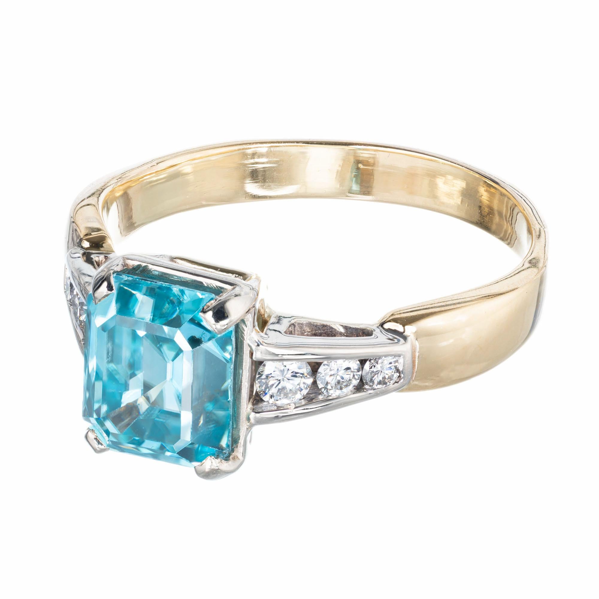 Vintage 1960's 3.70 carat emerald cut blue zircon and diamond engagement ring in a 14k yellow and white gold setting.  

1 emerald cut blue zircon, approx. 3.7cts
6 round brilliant cut diamonds, H-I VS-SI, approx. .22cts
Size 9 and sizable
14k