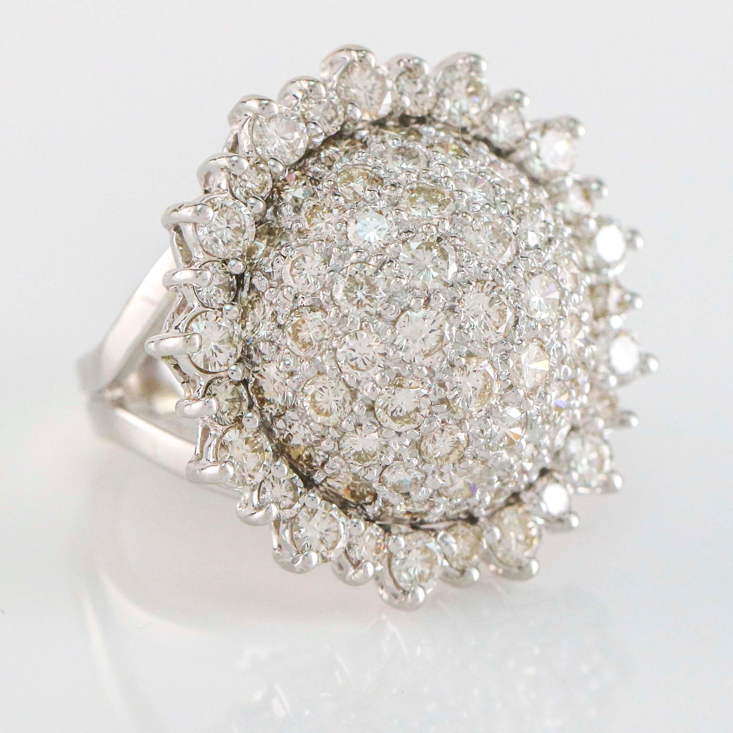 Sunflower motif ring in 14 karat white gold. Size 7. The ring is pave set with 3.75 carats of round cut diamonds.