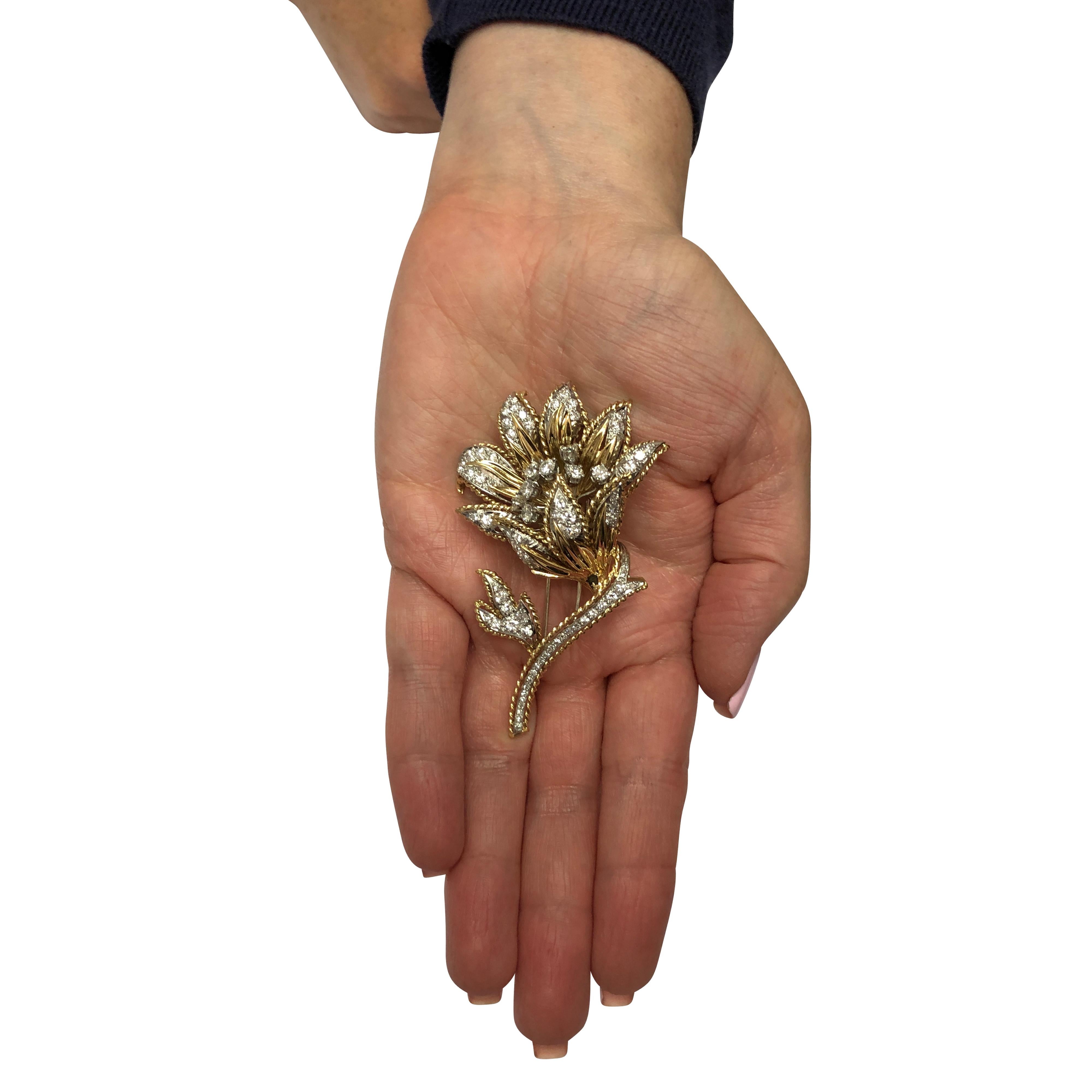 Beautiful brooch pin crafted in 18 karat yellow gold and platinum showcasing 80 round brilliant and single cut diamonds weighing 3.75 carats total, F color, VS clarity set in a flower design, capturing the unparalleled beauty of nature. This