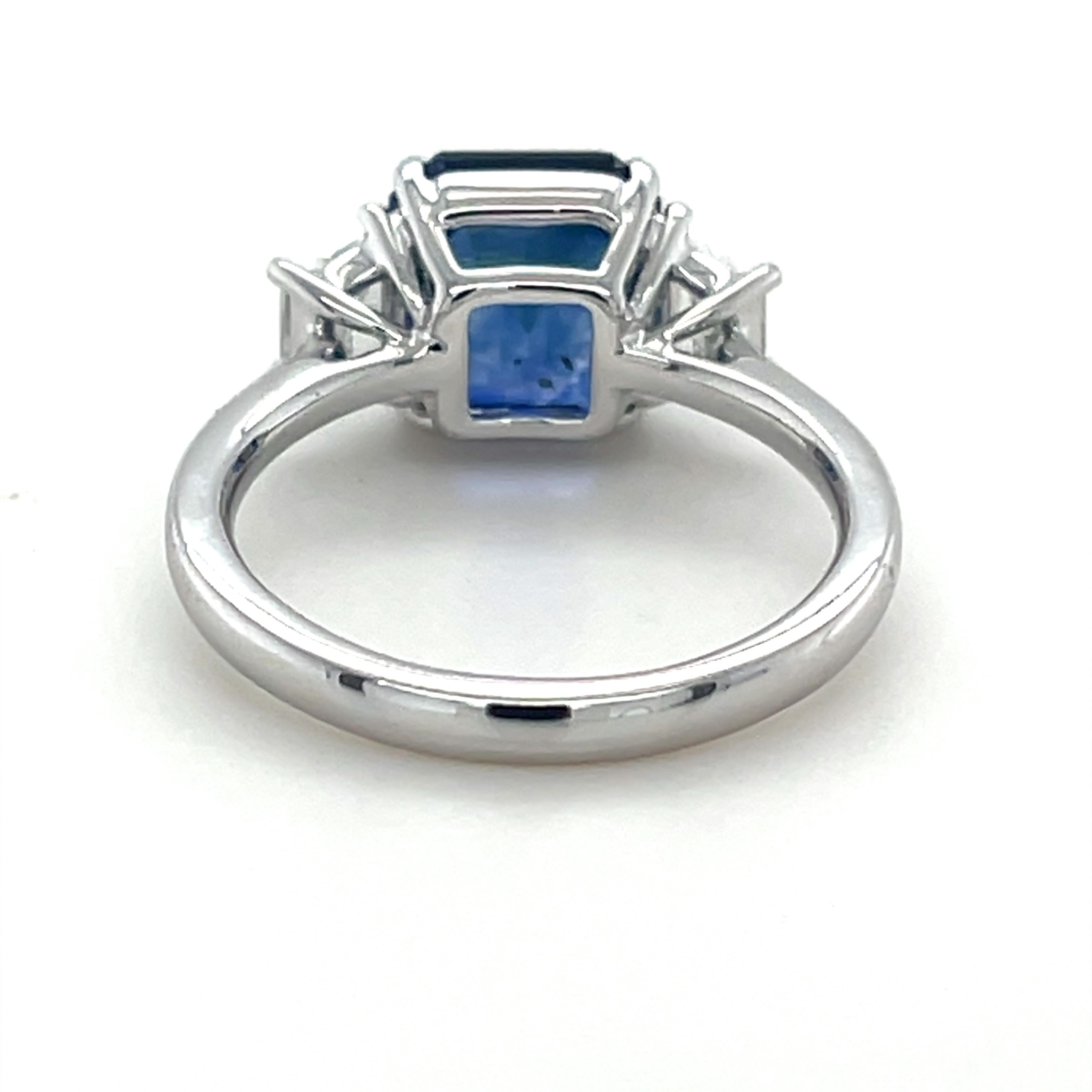 Modern 3.75 Carat Emerald Cut Ceylon Sapphire & Diamond Three Stone Ring in Platinum For Sale