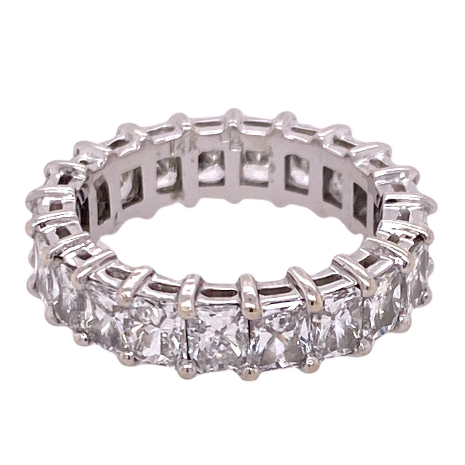 Gorgeous emerald cut diamond eternity band hand crafted in 14 karat white gold. The band features 21 perfectly matched emerald cut diamonds weighing 3.75 carat total weight. The diamonds are graded G-I color and VS2-SI1 clarity. The band measures