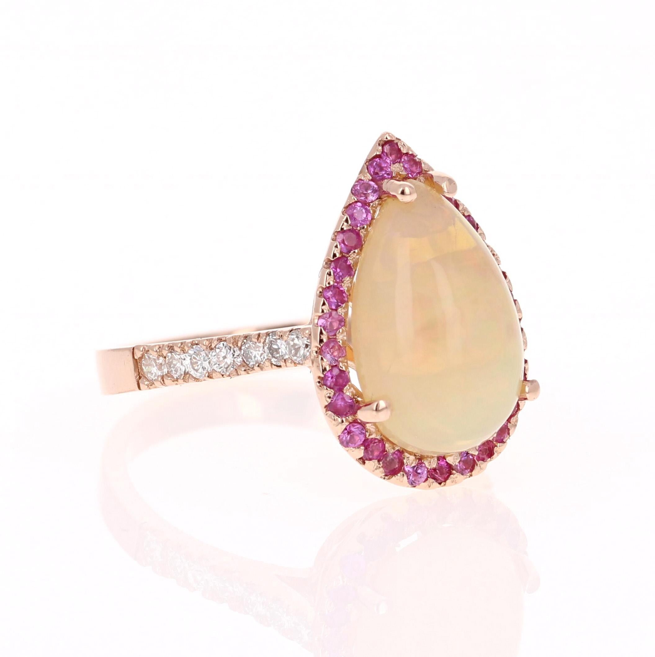 Unique and beautifully designed ring that can be a masterpiece to anyone's jewelry collection!   

This ring has a magnificently large 3.04 Carat Natural Pear Cut Opal and is surrounded by 32 Natural Pink Sapphires that weigh 0.40 Carats and is