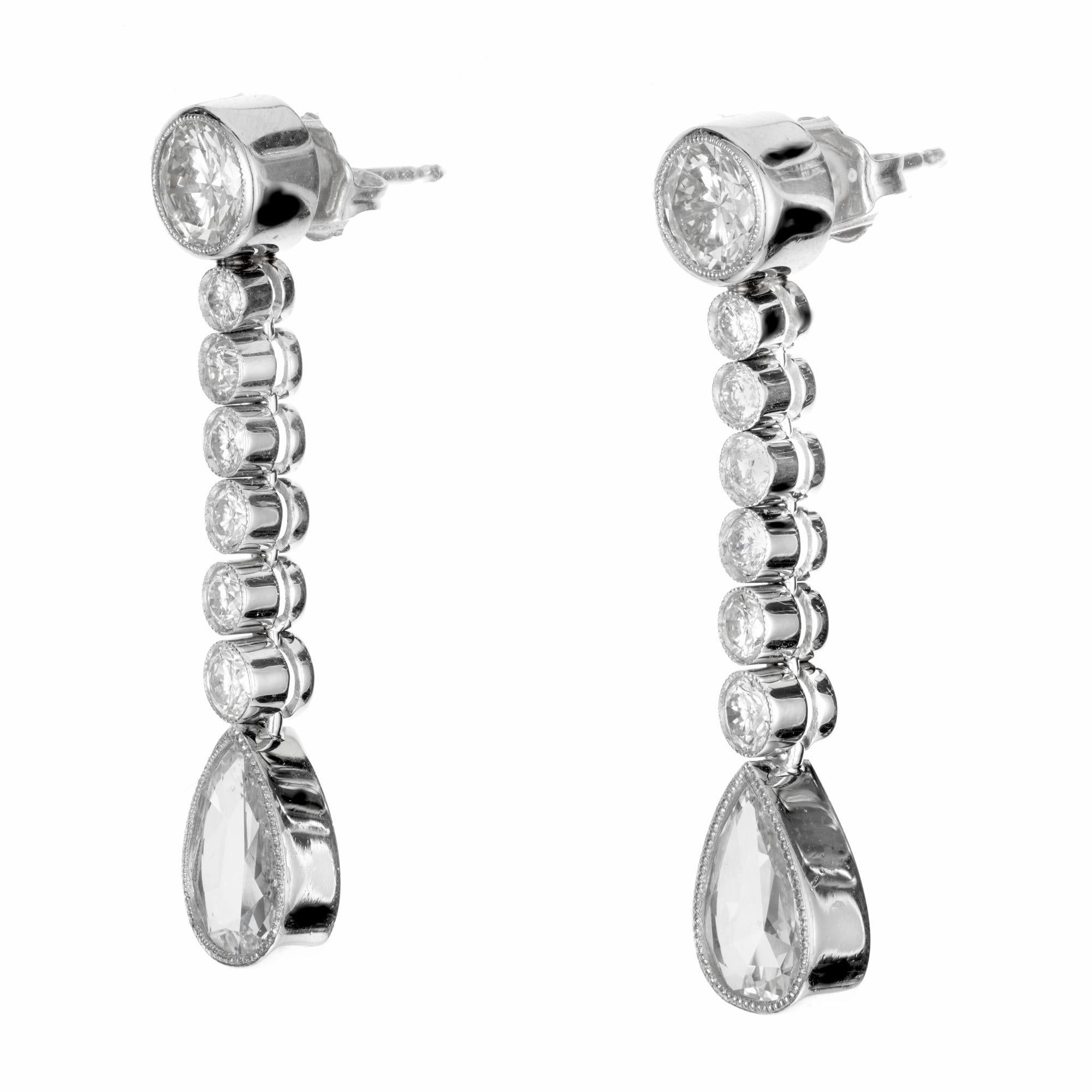 Diamond dangle drop earrings.  2 brilliant round cut beaded bezel set diamonds, 1.37cts total. Each with a row of 6 round cut diamonds totaling .48cts with two EGL certified pear shaped diamond at each end totaling 1.90cts. 

2 round diamonds,