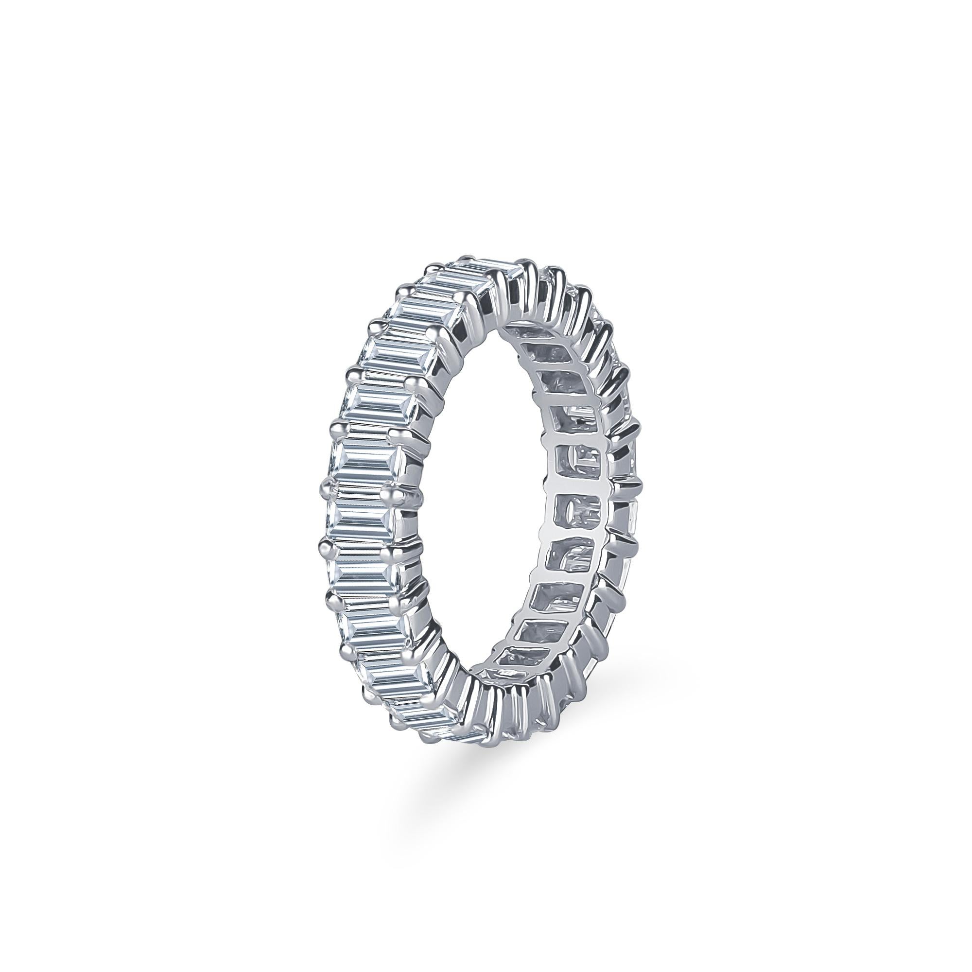 3.75 Carat total weight of emerald cut natural diamonds prong set in a platinum eternity band with a total width of 4.5mm. 
Ring size 5.75. Diamond clarity VS1-VS2 Color F-G.