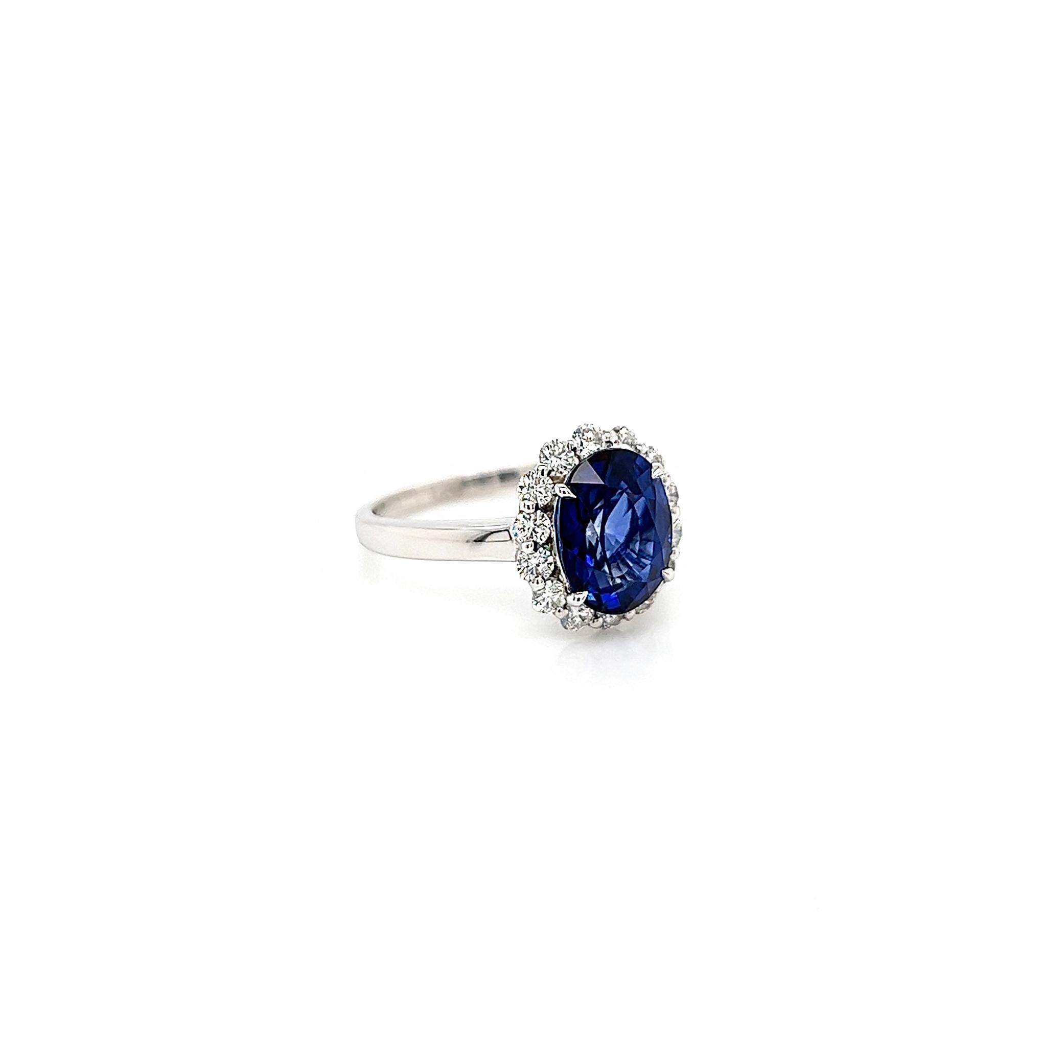 Oval Cut 3.75 Total Carat Oval Blue Sapphire and Diamond Halo Ladies Engagement Ring For Sale