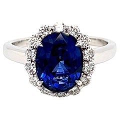 3.75 Total Carat Oval Blue Sapphire and Diamond Halo Ladies Engagement Ring