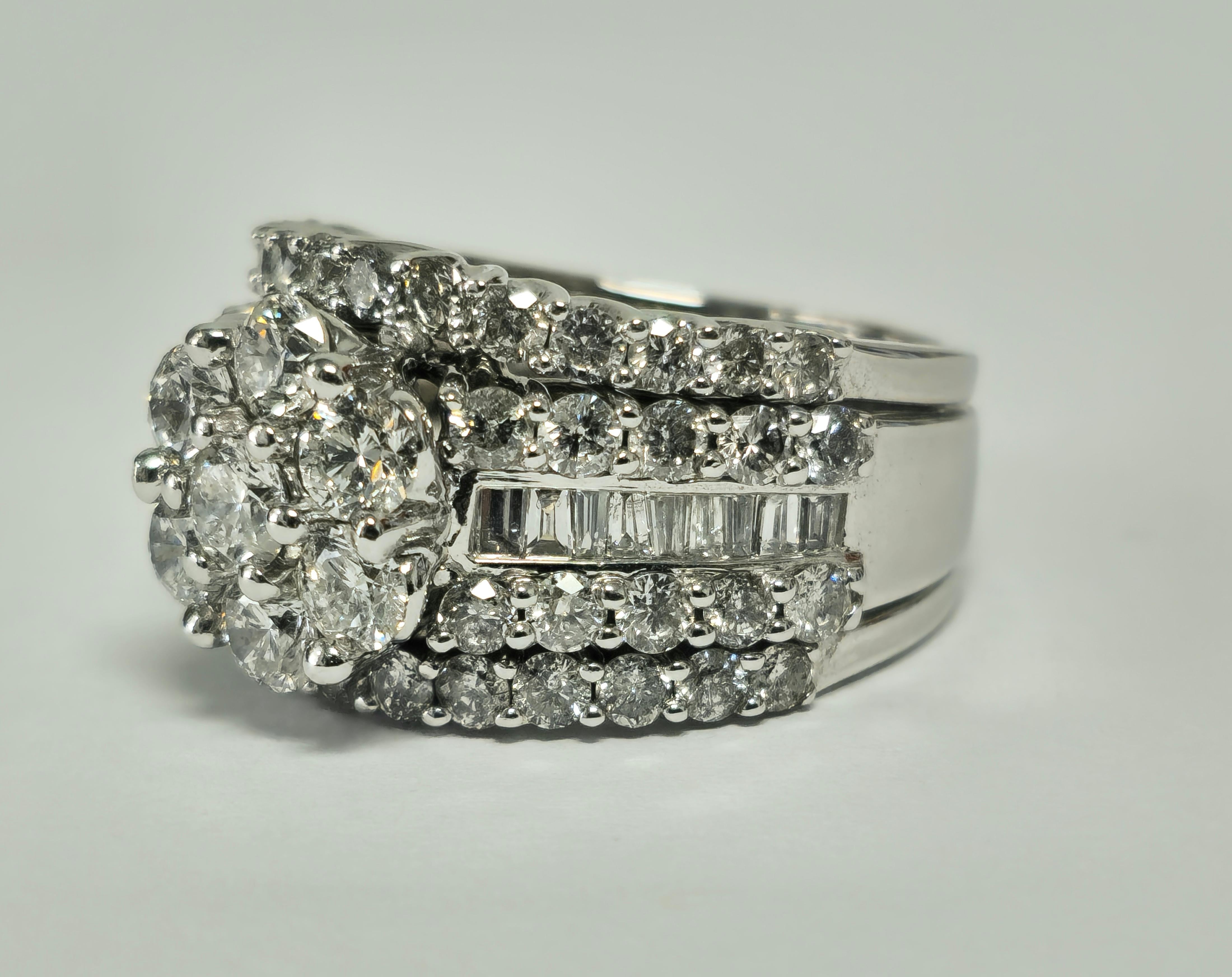 From solid 14k white gold, this stunning ring features a total carat weight of 3.75cts, showcasing a combination of round brilliant and baguette cut diamonds set in prongs or channel setting. With diamonds boasting VS-SI clarity and G color, the