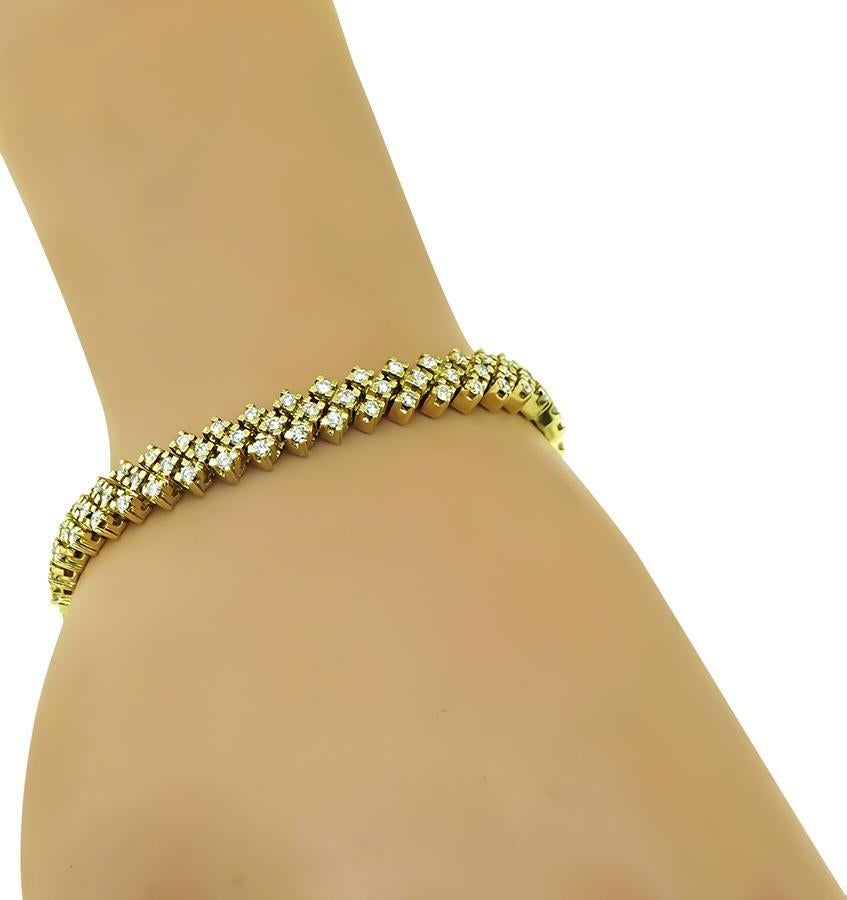 This is an elegant 14k yellow gold bracelet. The bracelet is set with sparkling round cut diamonds that weigh approximately 3.75ct. The color of these diamonds is G with VS clarity. The bracelet measures 7.5mm in width and 6 3/4 inches in length.