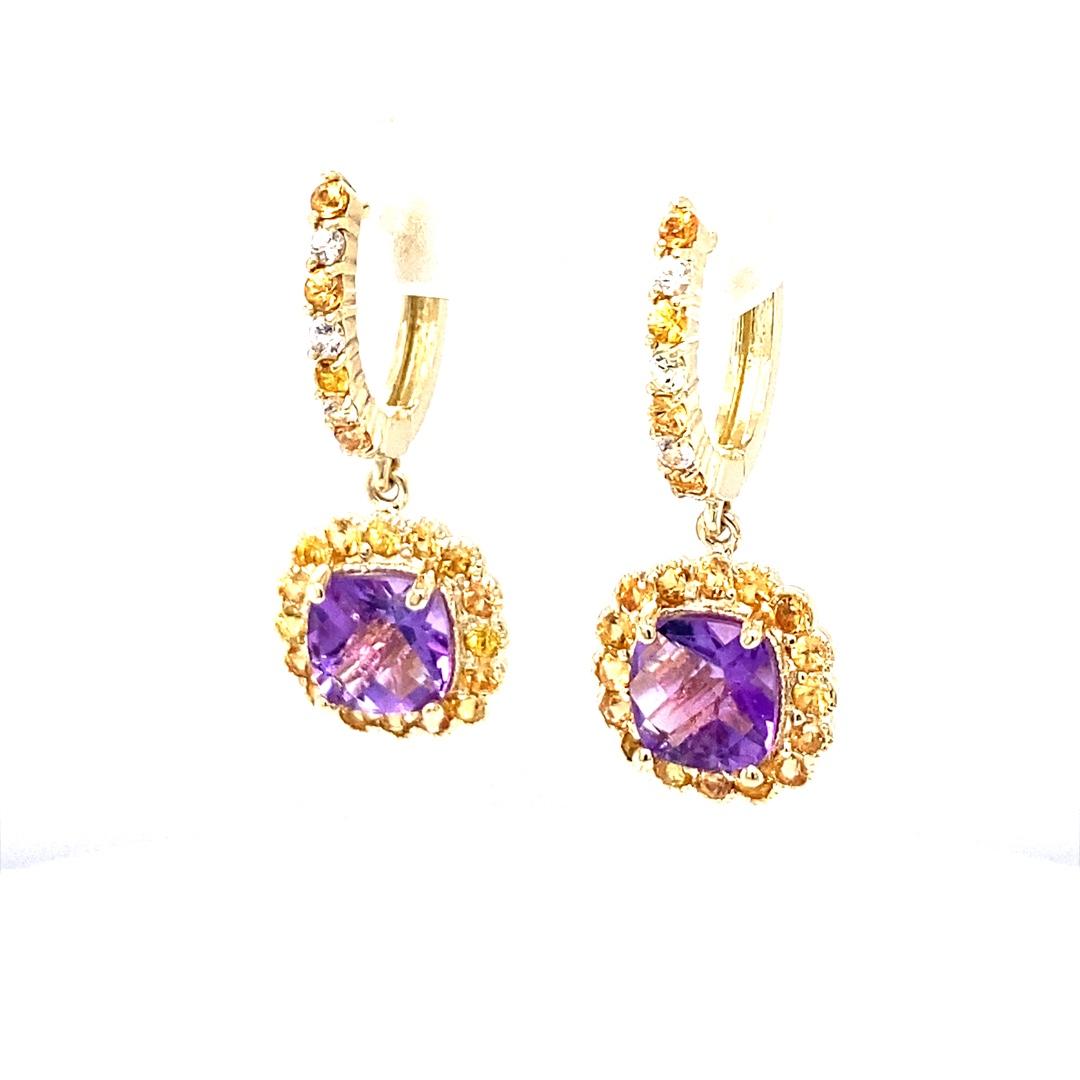 These earrings have 2 Cushion Cut Amethysts that weigh 2.40 Carats and are embellished with 46 Round Cut Yellow and White Sapphires that weigh 1.36 Carats. The Total Carat weight of the Earrings are 3.76 Carats. 
The Earrings are about an 1.2 inches