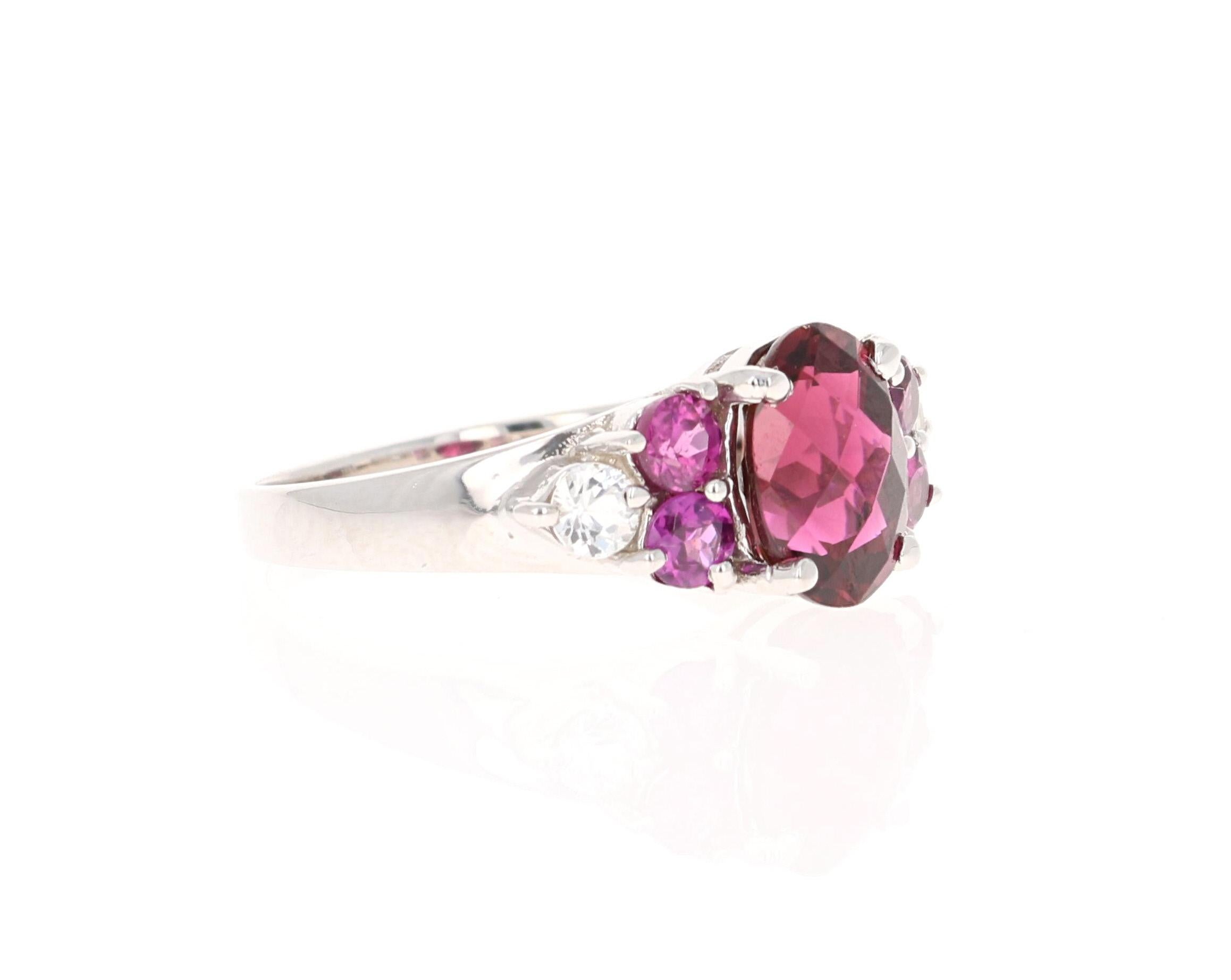 This ring has an Oval-Checkered Cut Purple Tourmaline that weighs 2.50 carats. There are 4 Purple Garnets and 2 White Sapphires that weigh 1.26 carats. The total carat weight of the ring is 3.76 carats. 

This ring is casted in 14K Yellow Gold and