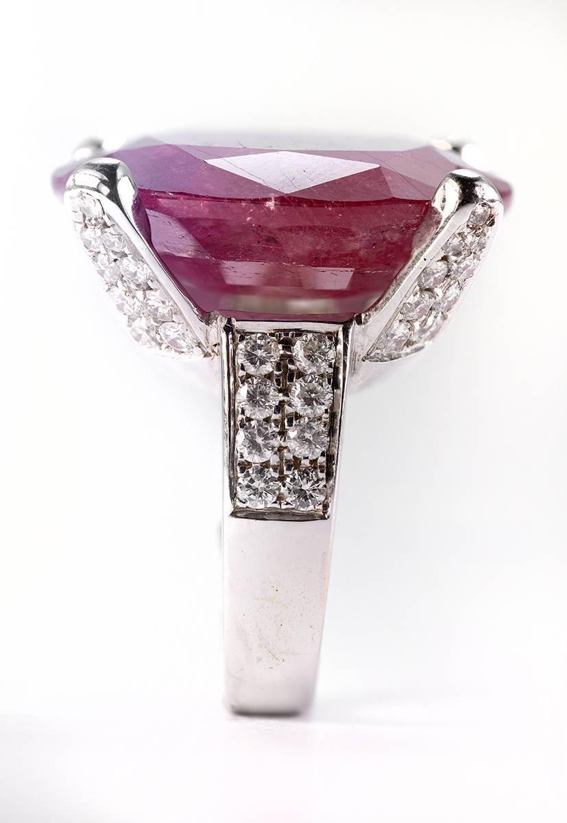 One of a Kind African Ruby 37.66 Carat set in 18 Karat White Gold four prong setting featuring 1.61 Carat Diamonds of H Color and VS Clarity. The Ruby is opaque with a beautiful red color with pink overtones. The ring size is 49 and can be easily