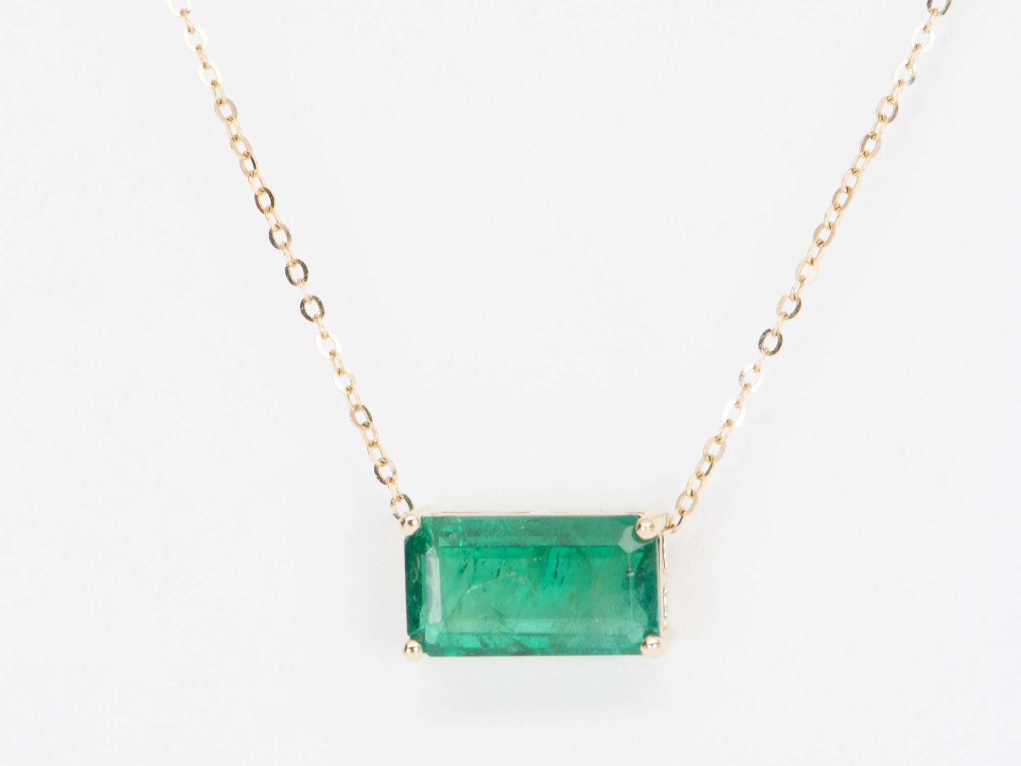 This elegant, timeless necklace features a stunning 3.76ct rich green Zambian emerald that is the focal point of the design. The emerald is set into a classic prong design that can be worn vertically or horizontally on the chain to suit any