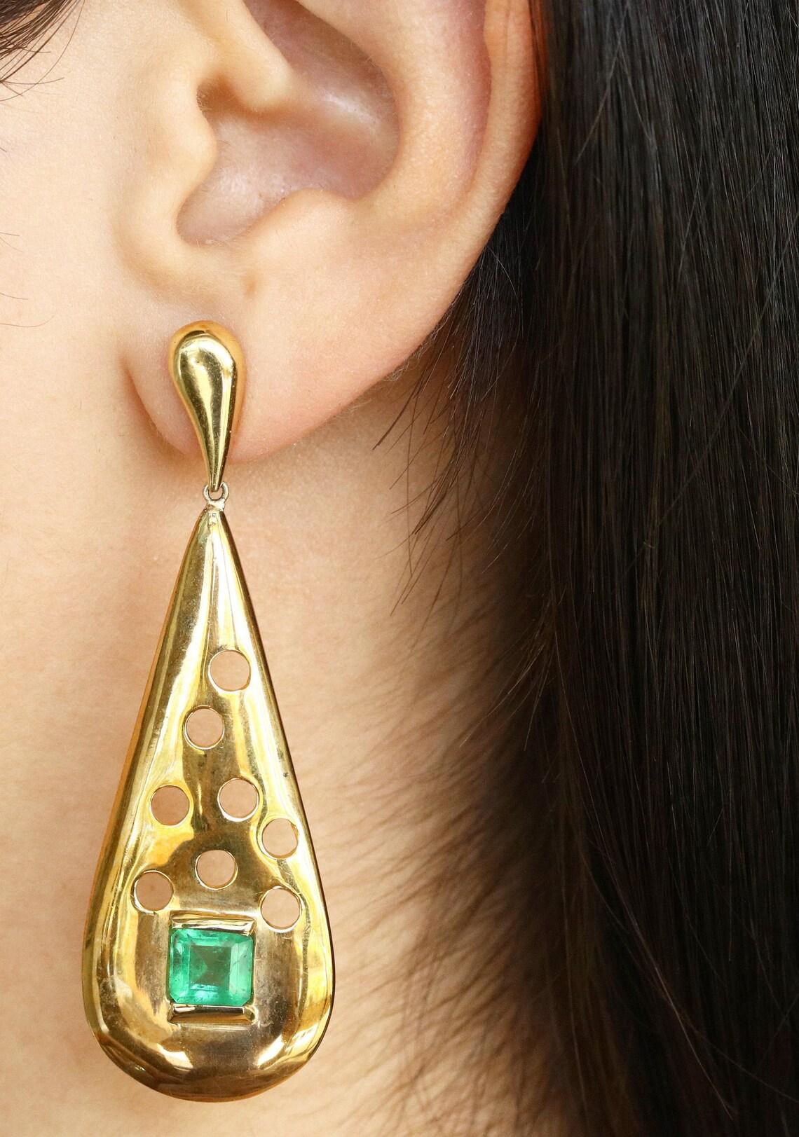 A sumptuous 3.76-carat pair of square-cut rich green Colombian emeralds and gold stud drop earrings. Handcrafted in our shop with solid high quality 14K yellow gold, each earring features an incredible emerald cut stone. These fine emeralds are