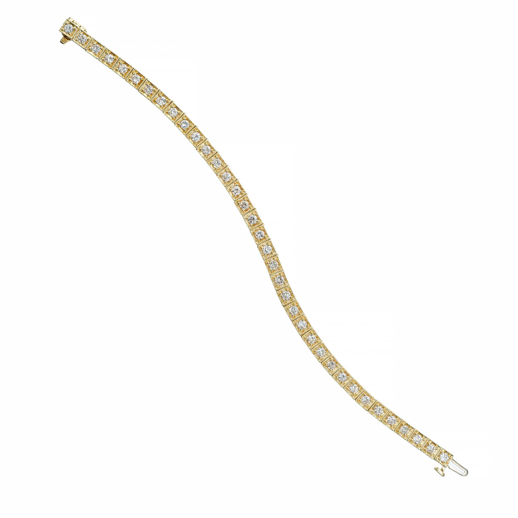 Diamond yellow gold tennis bracelet. 36 round brilliant cut diamonds totaling 3.77cts, set in a 14k yellow gold heavy hinged box link bracelet. Each box is etched on both sides as well as the top frame, giving it a rich Etruscan style look. Built in
