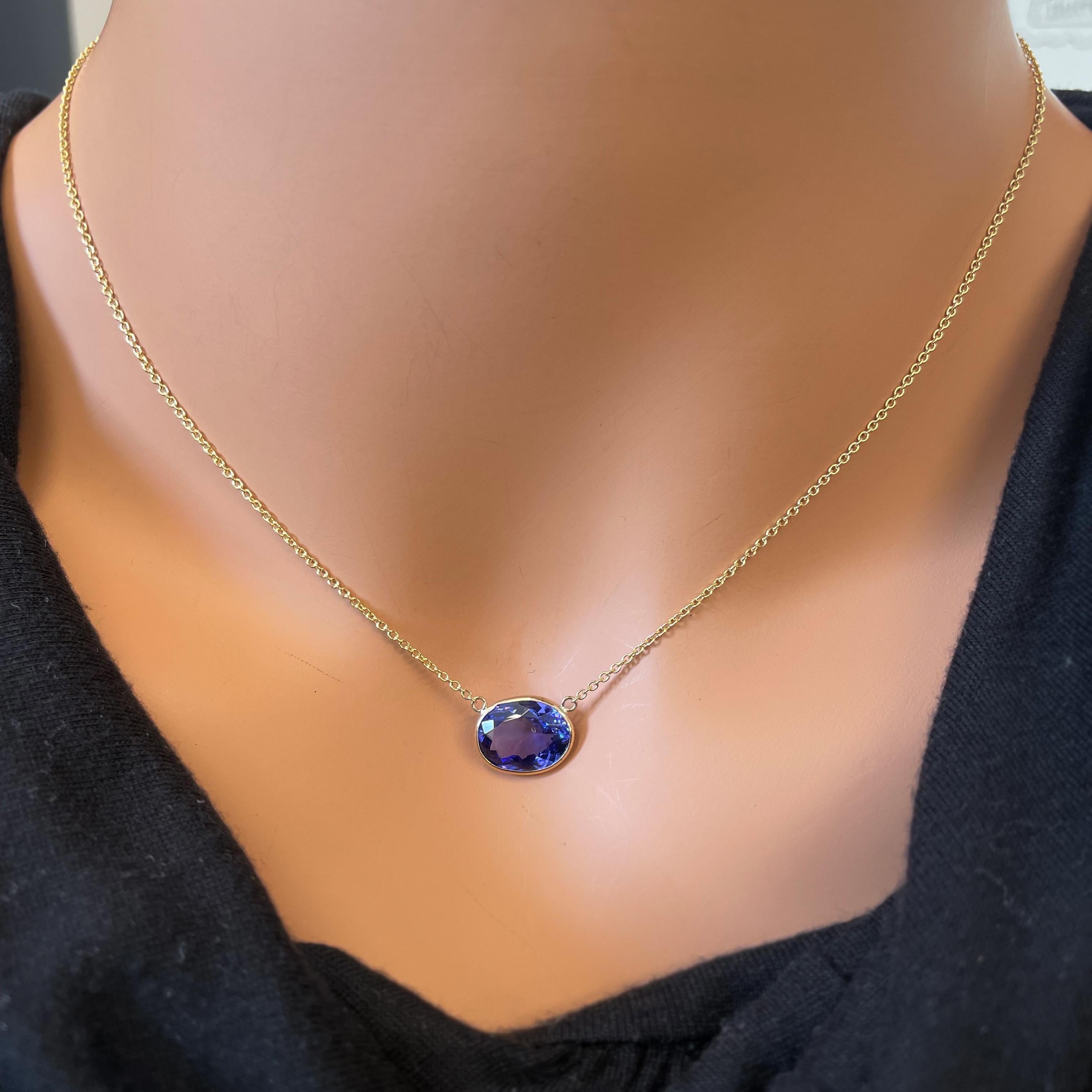 This necklace features an oval-cut Tanzanite with a weight of 3.77 carats, set in 14k yellow gold (YG). Tanzanite is a striking blue-violet gemstone known for its vivid color and allure. Oval cuts are also a popular choice for gemstones, as they