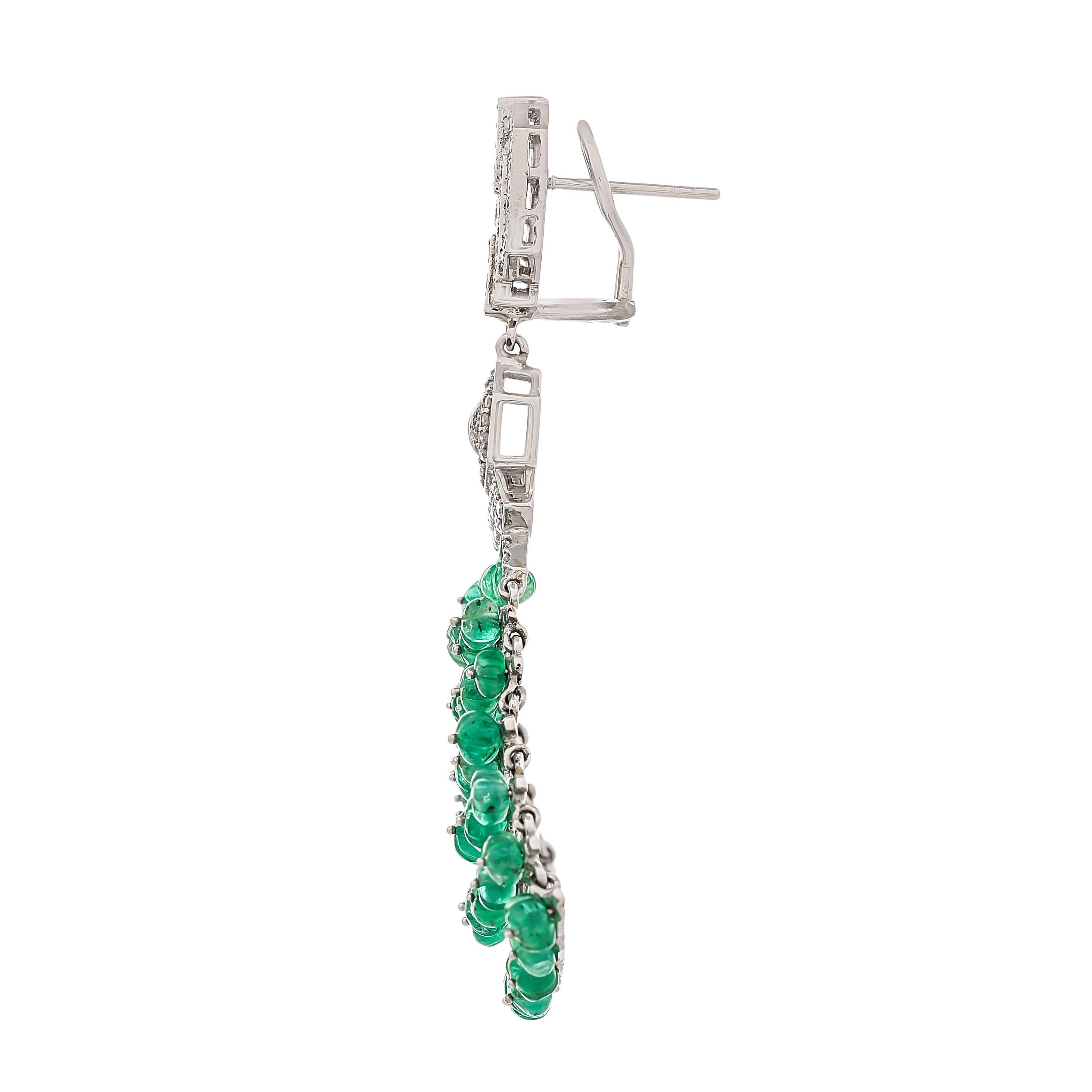 This modern era, emerald melon and diamond earrings are practically a work of art. Cast in 18 karats white gold, each earring features several finest carved emerald melon beads layered within 6 rows weighing approximately 37.71 carats held together