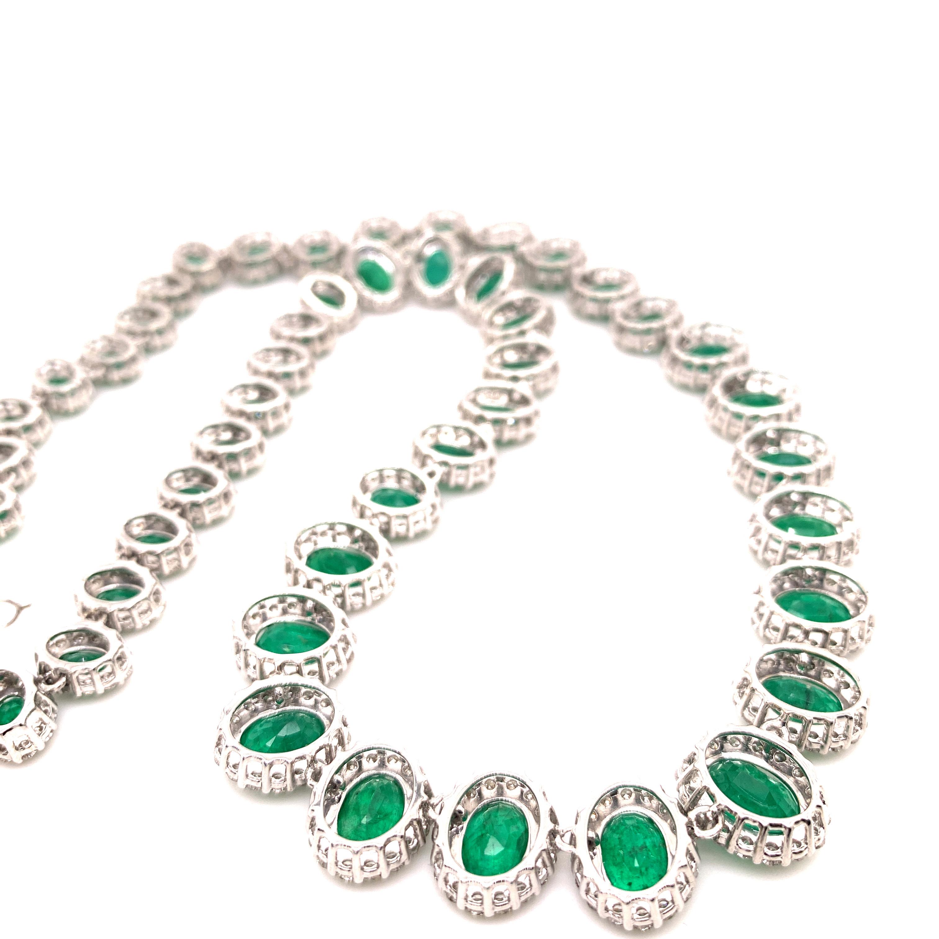 Timeless emerald diamond necklace earrings set. Lively intense green, high quality, high luster, oval faceted, 35.37 carats natural emeralds necklace, mounted in high profile open basket with bead prong, accented with round brilliant cut diamonds.