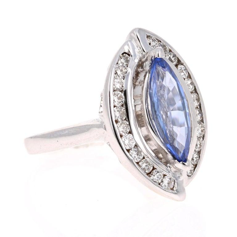 Gorgeous Cocktail Ring! 
This beautiful ring has a 3.04 Carat Marquise Cut Sapphire and is surrounded by 22 Round Cut Diamonds that weigh 0.74 Carats. The Total Carat Weight of the ring is 3.78 Carats.  

The Marquise Cut Sapphire measures at 14 mm