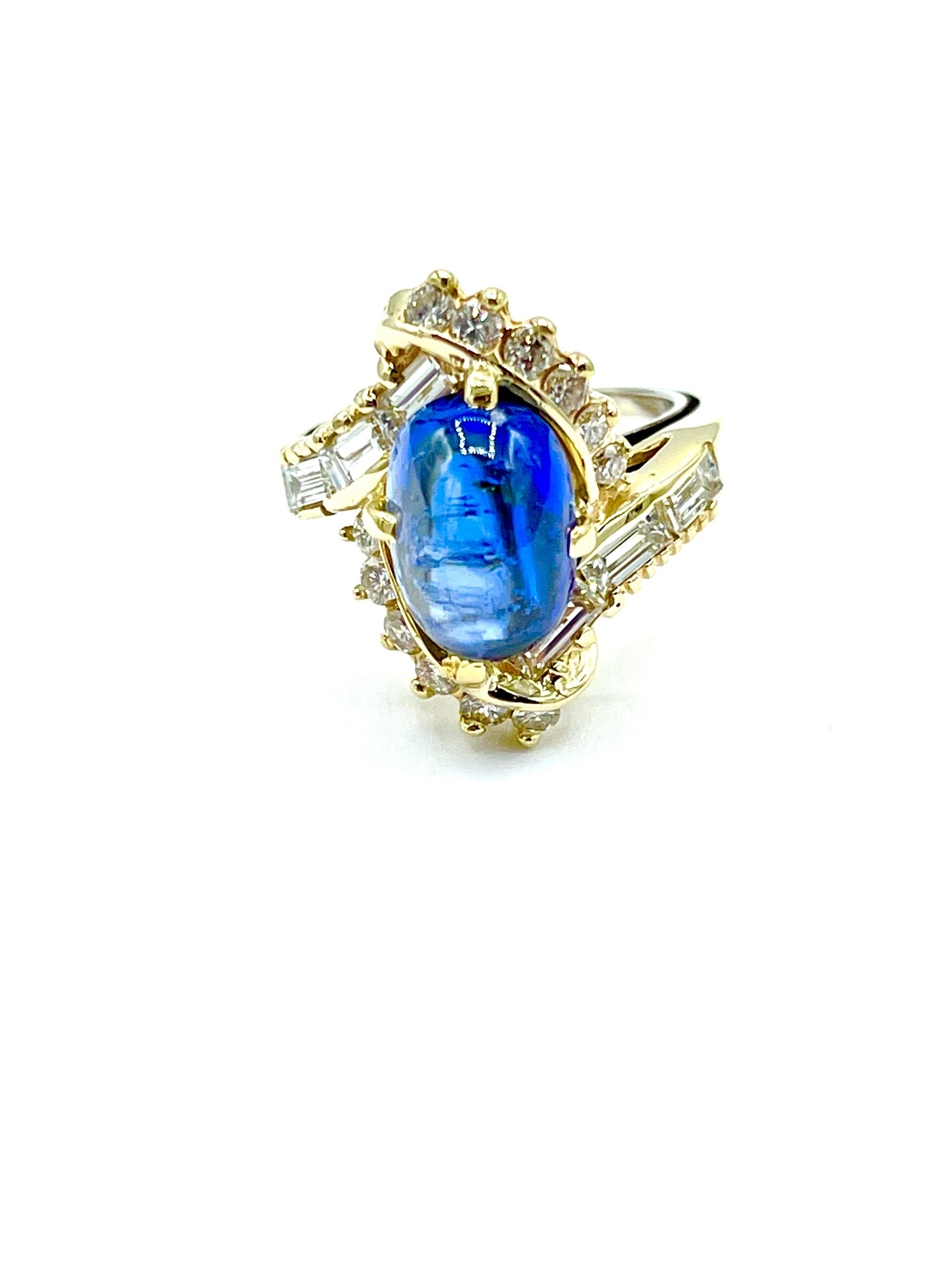 A beautiful 3.78 carat cabochon Sapphire and mixed cut Diamond cocktail ring in 14k yellow gold.  The Sapphire is set with four prongs surrounded by a single row of round brilliant and baguette Diamonds, that continues  down the top quarter of the