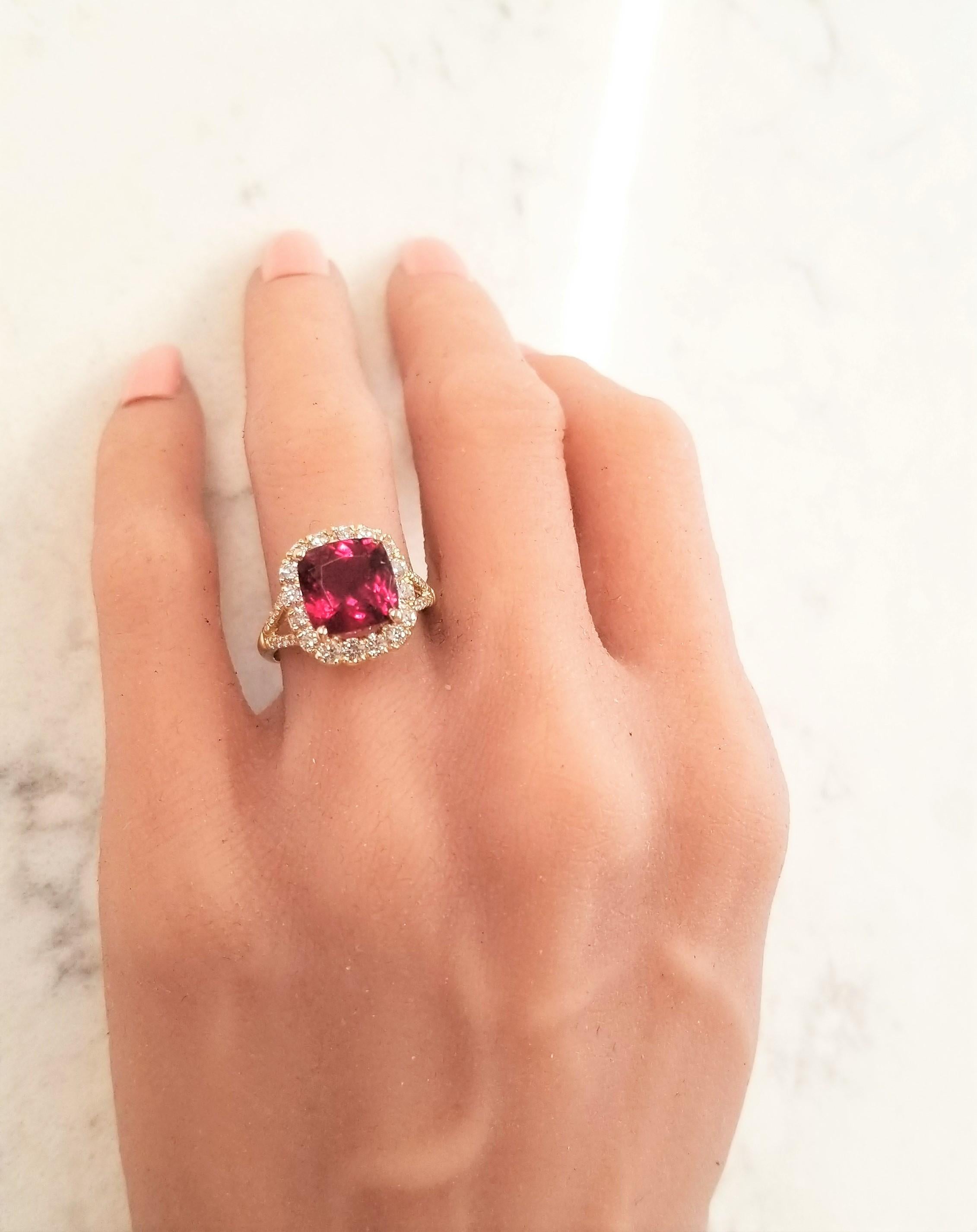 This cocktail ring features a 3.78 carat cushion cut rubellite tourmaline measuring 9.40-9.30mm. The gem source is Brazil; its color is intense, vibrant raspberry; its transparency, clarity, and luster are superb. It is accentuated by 36 round