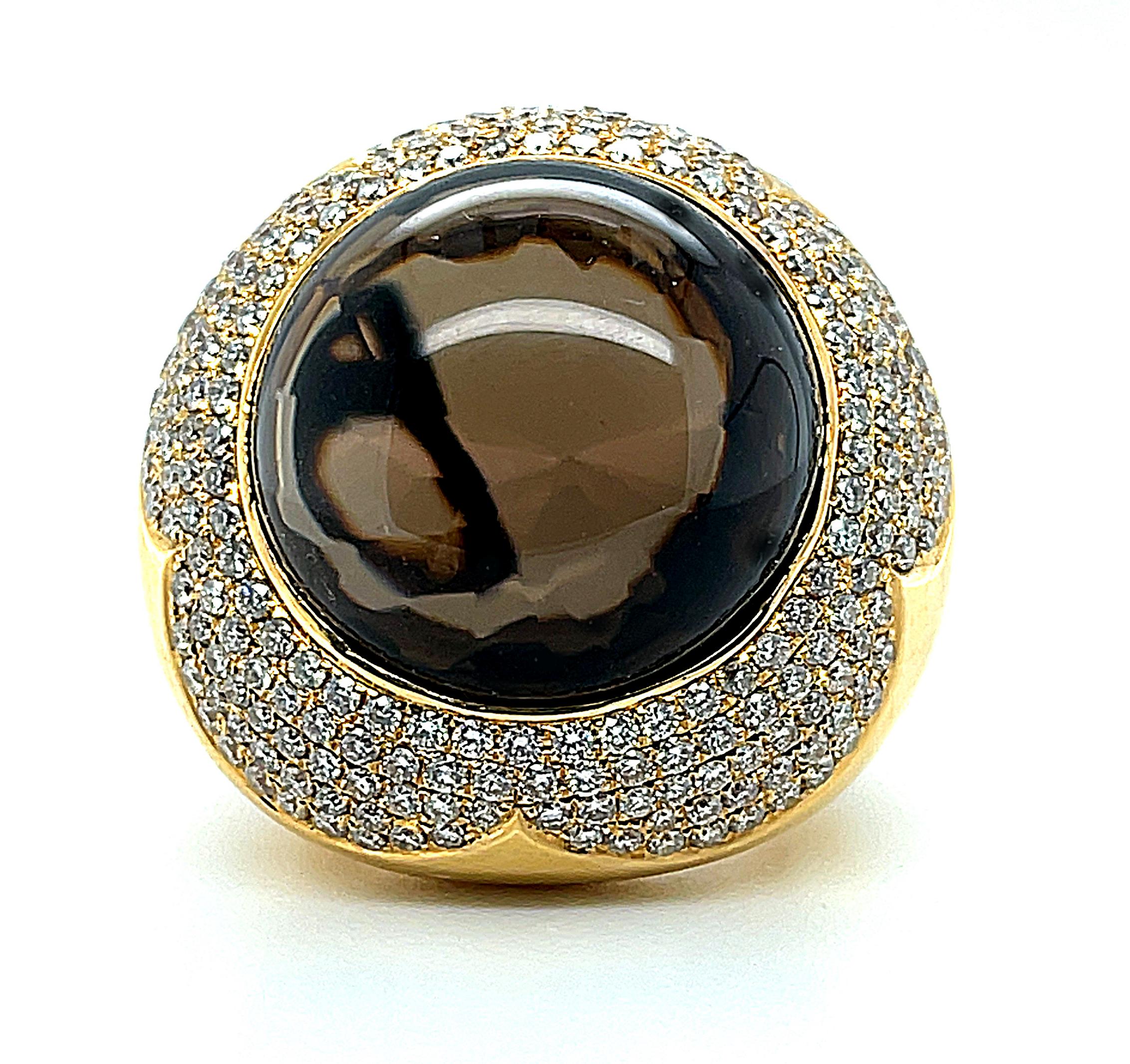 This impressive dome ring features a gorgeous, 37.87 carat coffee-colored smoky quartz cabochon that is sure to turn heads! The quartz is strikingly crystalline, with rich color that is complemented by the sparkling diamonds that 