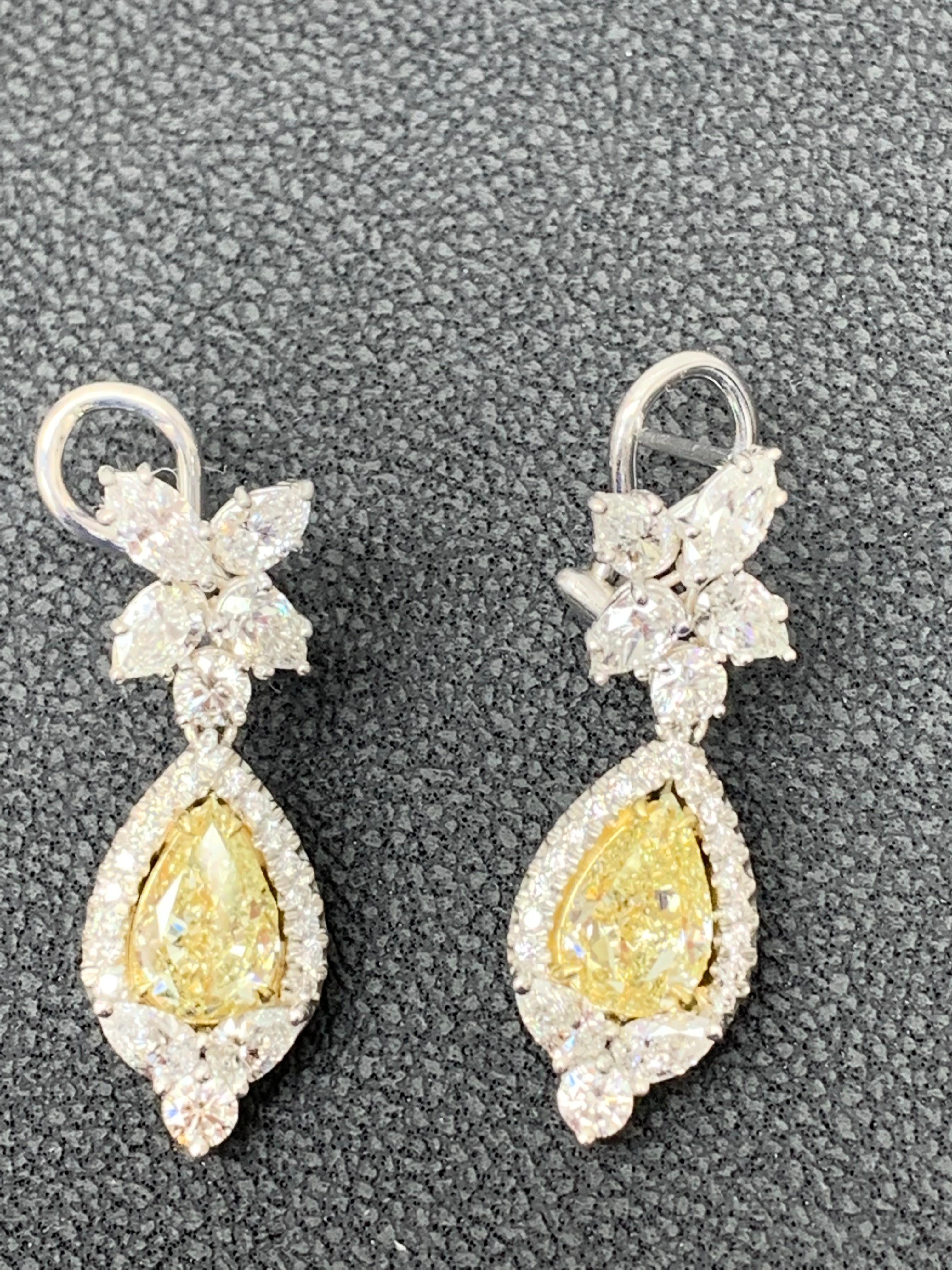 A beautiful and chic pair of drop earrings showcasing a cluster of brilliant mixed-cut diamonds, and pear-shaped brilliant yellow diamonds set in an intricate and stylish design.  10 Mixed cut Diamonds weigh 1.91 carats in total. 2 yellow diamonds