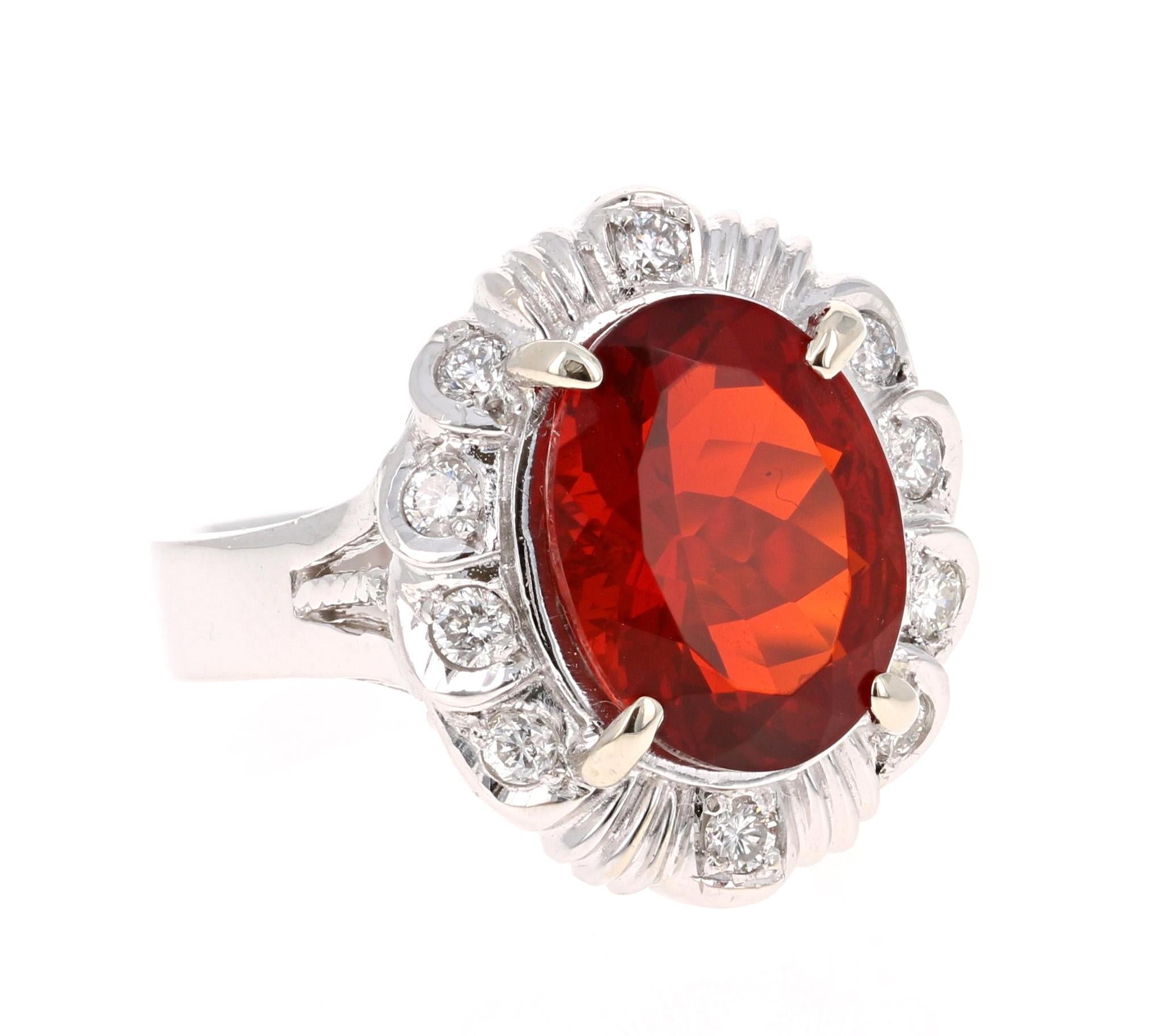 This gorgeous cocktail ring has a scintillating Oval Cut Fire Opal that weighs 3.42 carats and 10 Round Cut Diamonds that weigh 0.37 carats. (Clarity: SI2, Color: F)
The total carat weight of the ring is 3.79 carats.   
Crafted in 14K White
