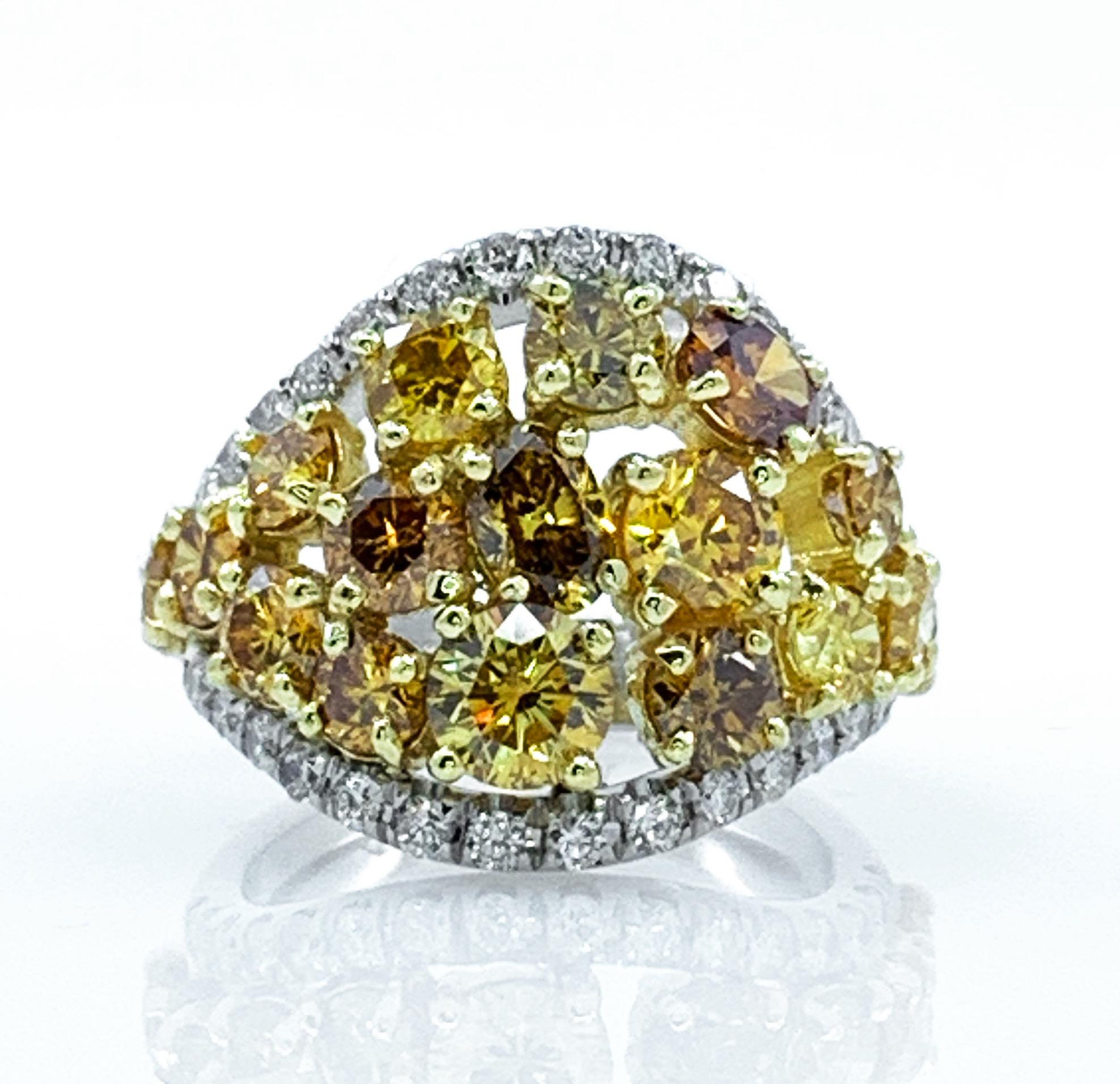 This extraordinary ring was designed and hand-finished in our shop by Eytan Brandes.  It's one-of-a-kind:  a special project undertaken by Eytan to showcase this particular little collection of beautiful yellow diamonds.

Covering half the