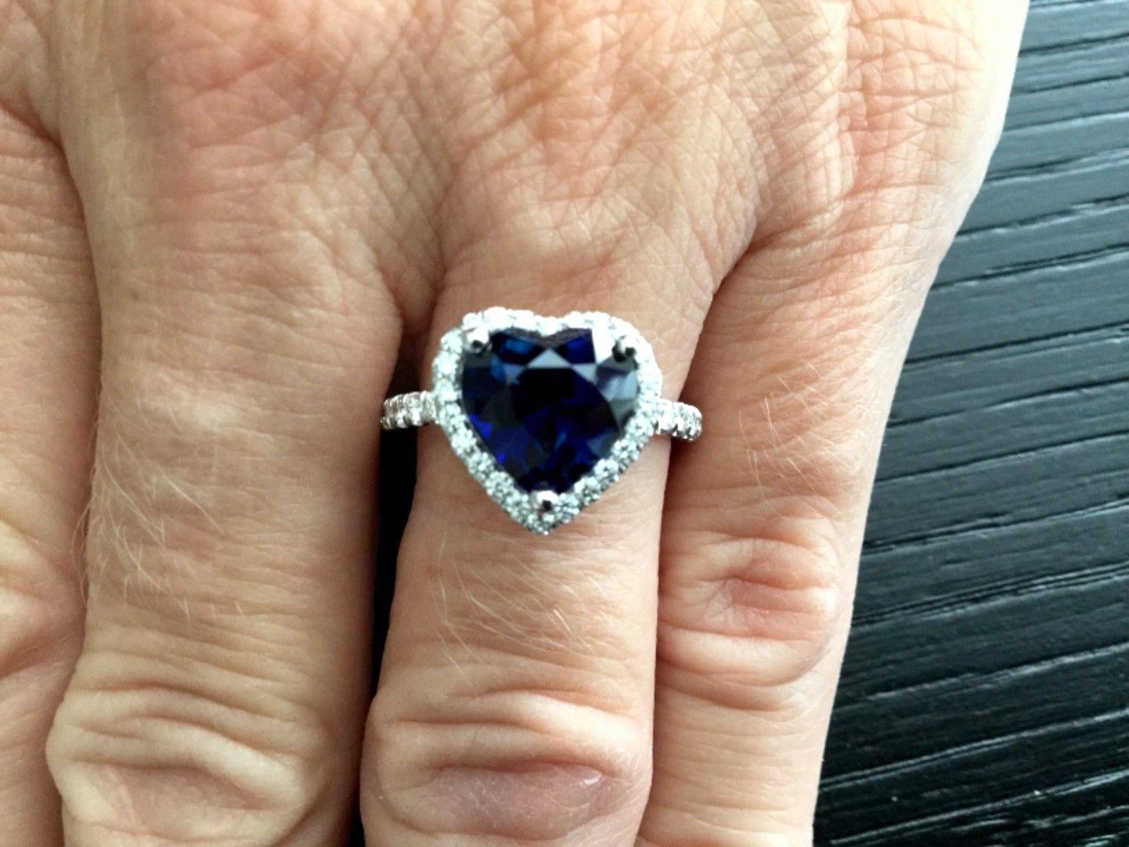 For your consideration is an investment grade 3.79 carat heart shaped, UNHEATED natural, transparent, blue Madagascar sapphire set in a brand new 14k white gold setting with approximately .75 carats of natural G color VS clarity white diamonds.  The