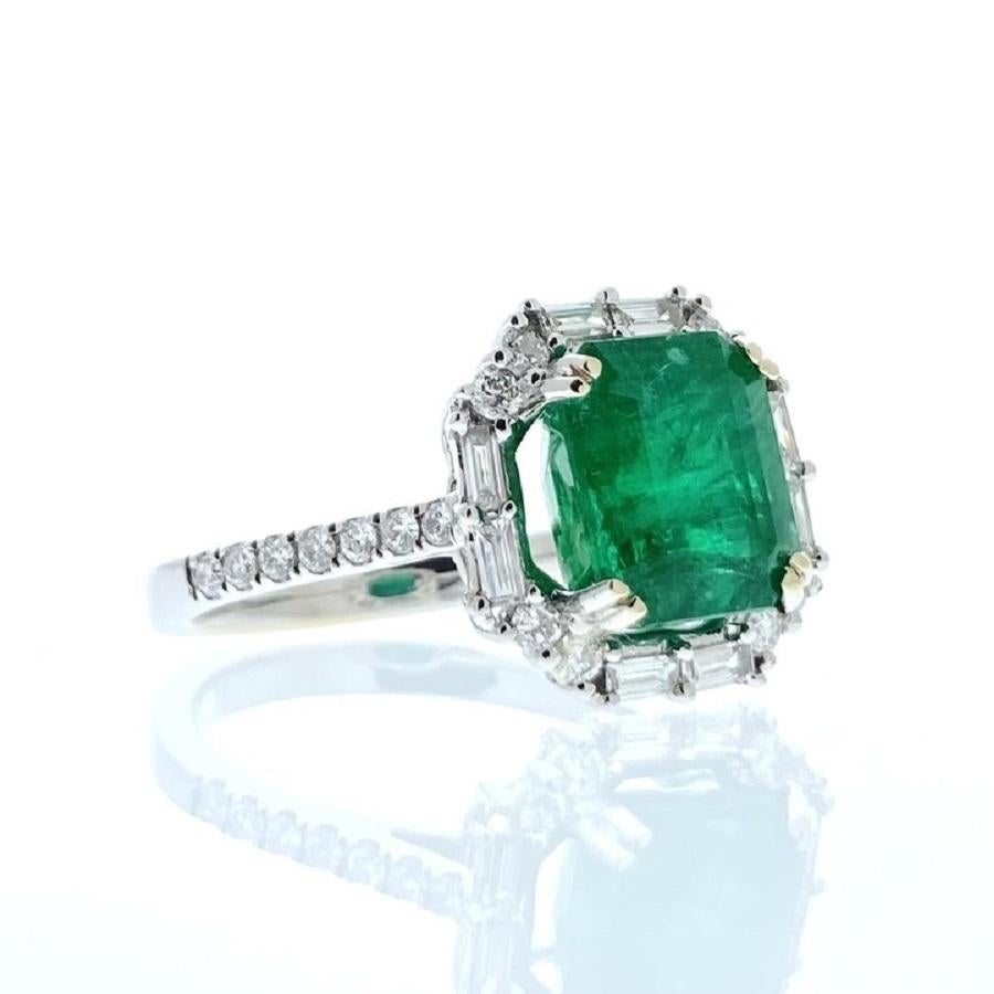 This ring is a breathtaking display of elegance and sophistication. Crafted in 18 karat white gold, it features a mesmerizing 3.79 carat octagonal-shaped green emerald as its focal point. The emerald's lush green hue captivates the eye, exuding a