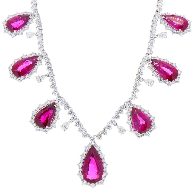 This jaw dropping diamond and rubellite necklace is a Red Carpet worthy piece of fine jewelry! The luxuriously dripping design features vibrant, pear shape fuchsia rubellite drops with sparkling pear shape diamonds stationed between each one. The