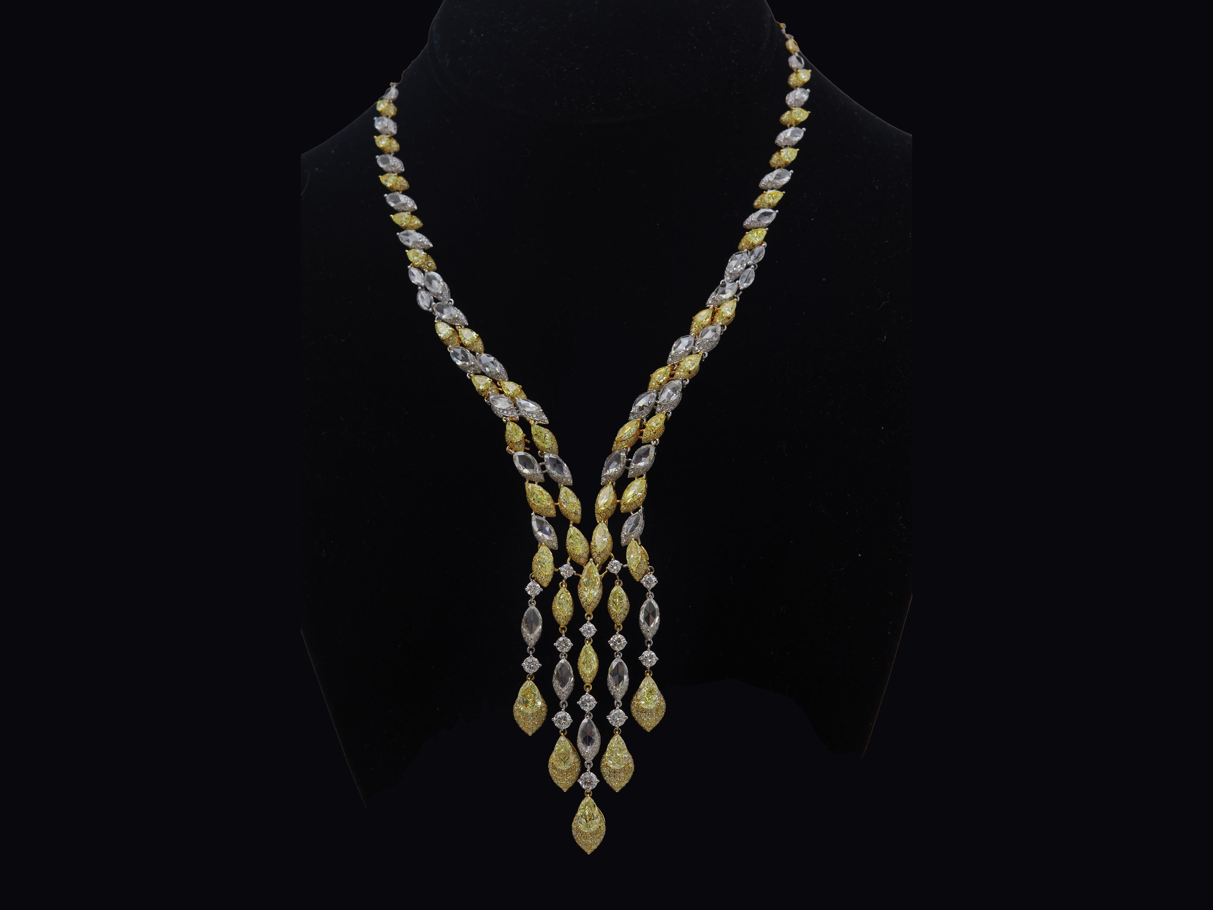 This luxurious design diamond necklace features 5 fancy light yellow diamonds 5.14 carat total weight Pear shape, GIA certified as SI1-VS2 clarity and 2 fancy yellow diamonds 1.06 carat marquis shape, GIA certified as VS1 clarity. suspended with
