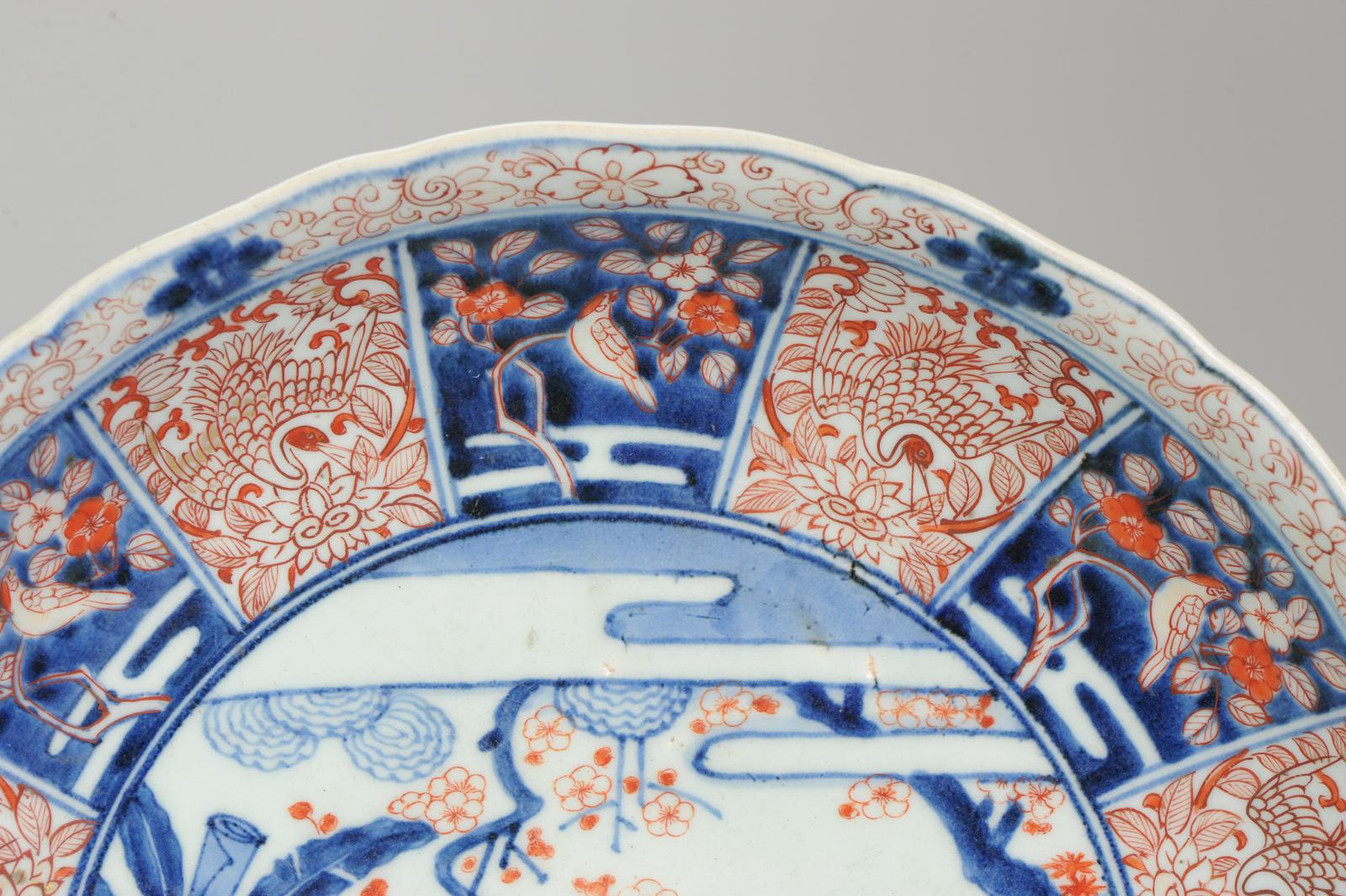 Sharing with you a large Japanese Porcelain dish (37cm) with a quite unusual Imari scene of a women in a garden scene with 4 children and dogs. On the right Shou Lao is visible on a cloud who seems to be watching over them. The cavetto has