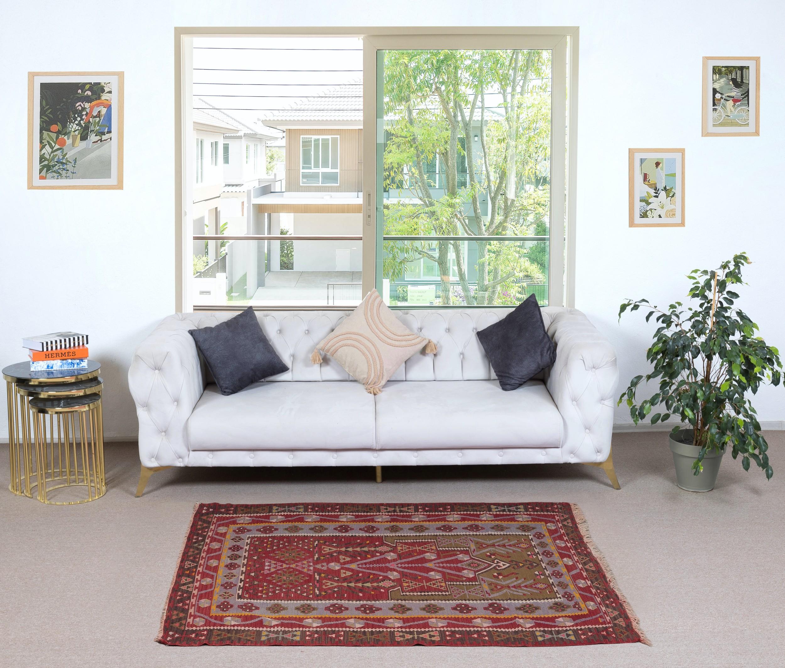 Embark on a journey through Turkish tradition with this exquisite vintage handwoven Turkish wool kilim rug, a testament to the enduring craftsmanship of Anatolian artisans. Woven with meticulous care and attention to detail, this kilim rug
