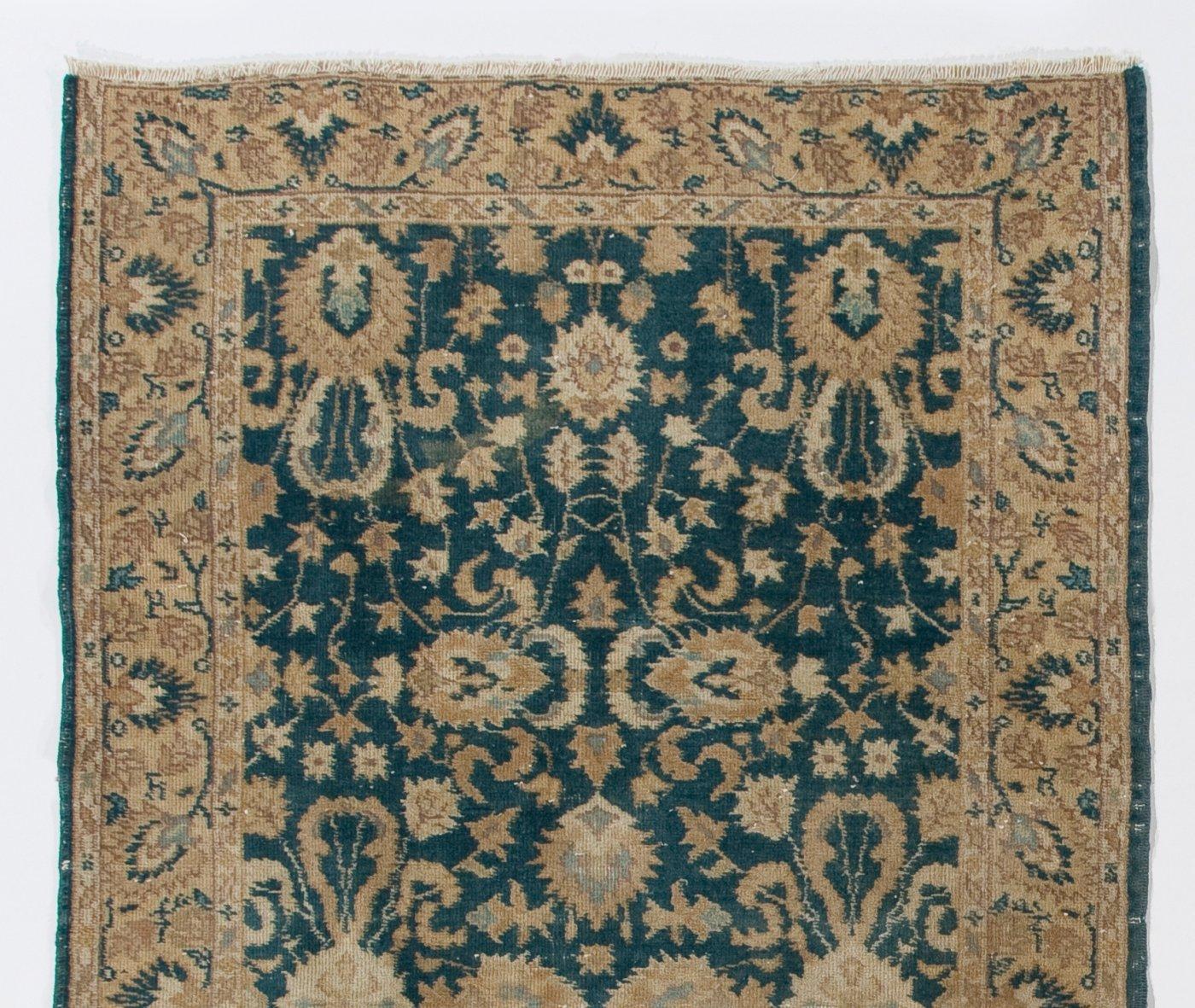 This vintage Central Anatolian accent rug in green and beige colors. It was hand-knotted in the 1950s and floral design. Low wool pile on finely woven cotton foundation. Sturdy and can be used on a high traffic area, suitable for both residential