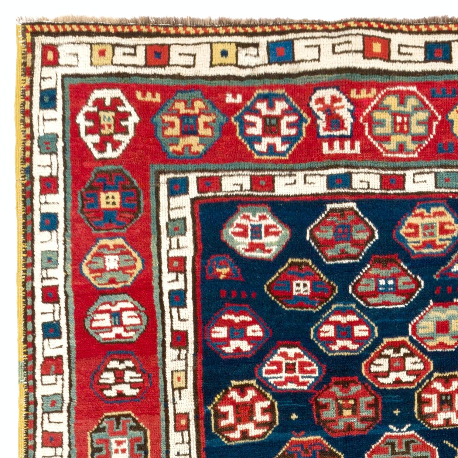 A traditional unique South East Caucasian Talish long rug with a beautiful geometric design. Note the little human and animal figures as well as the earrings, kites, flowers, combs and wheels of fortune motifs on the dark indigo blue field. A truly
