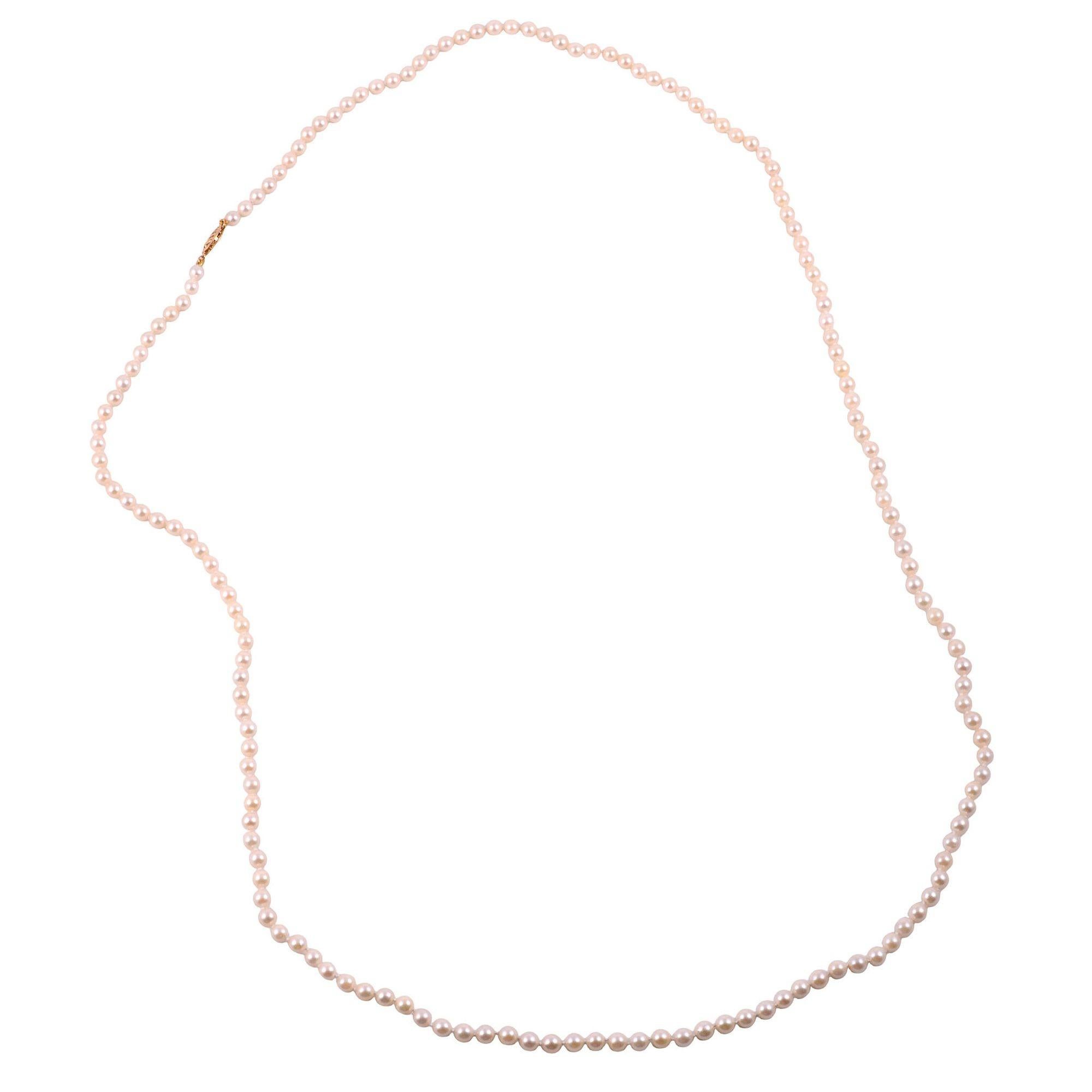 Estate 38 inch Akoya pearl necklace. This 38 inch strand of Akoya pearls is secured with a 14 karat gold pearl clasp. [KIMH 524]